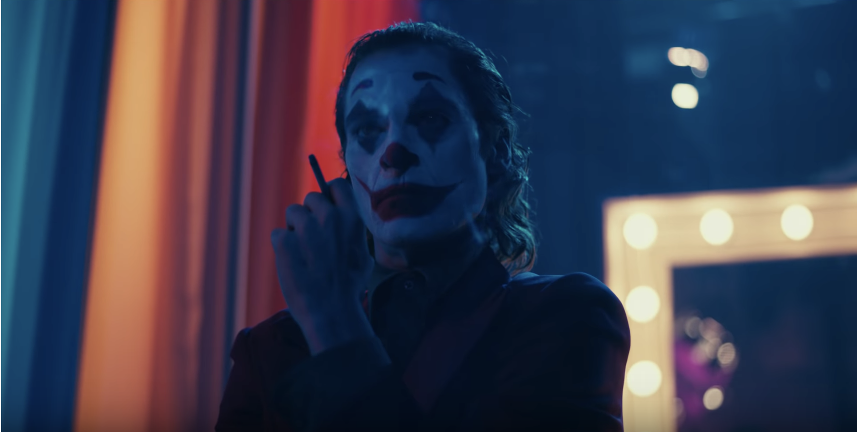 The Joker smokes a cigarette.