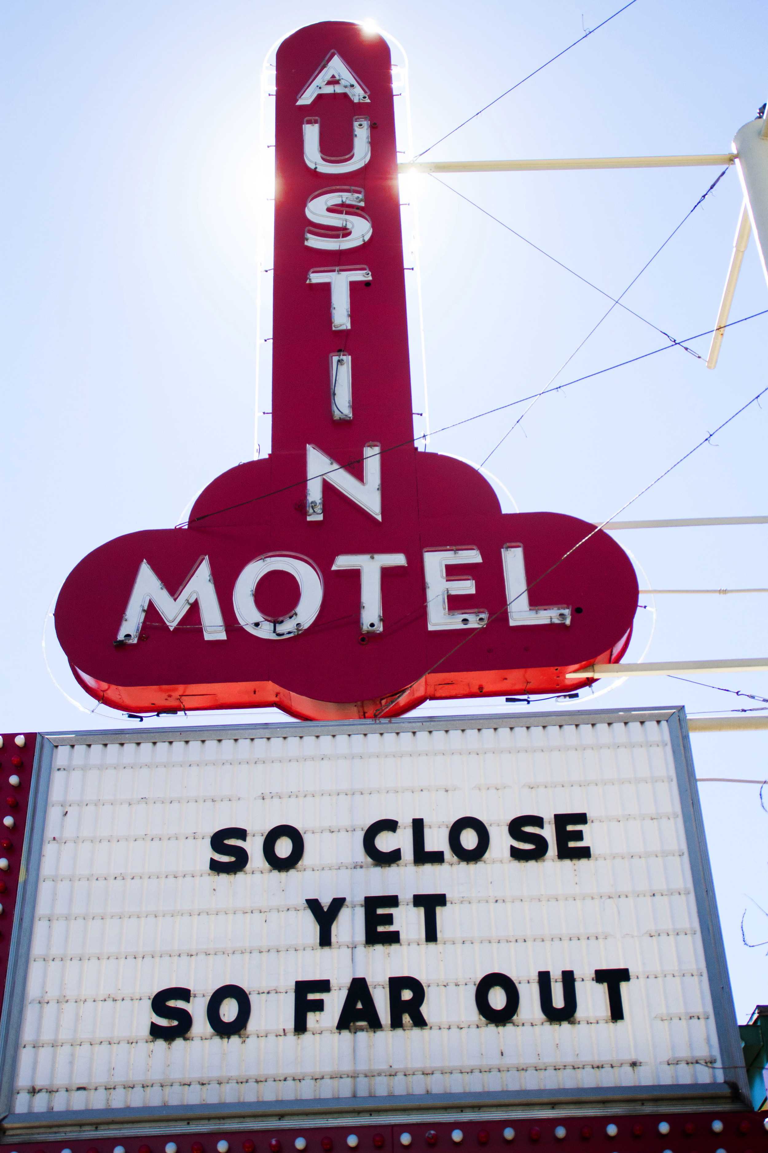   “So close yet so far out.” The Austin Motel’s marquis represents Austin’s wacky vibe, as the sun shines down on South Congress.  