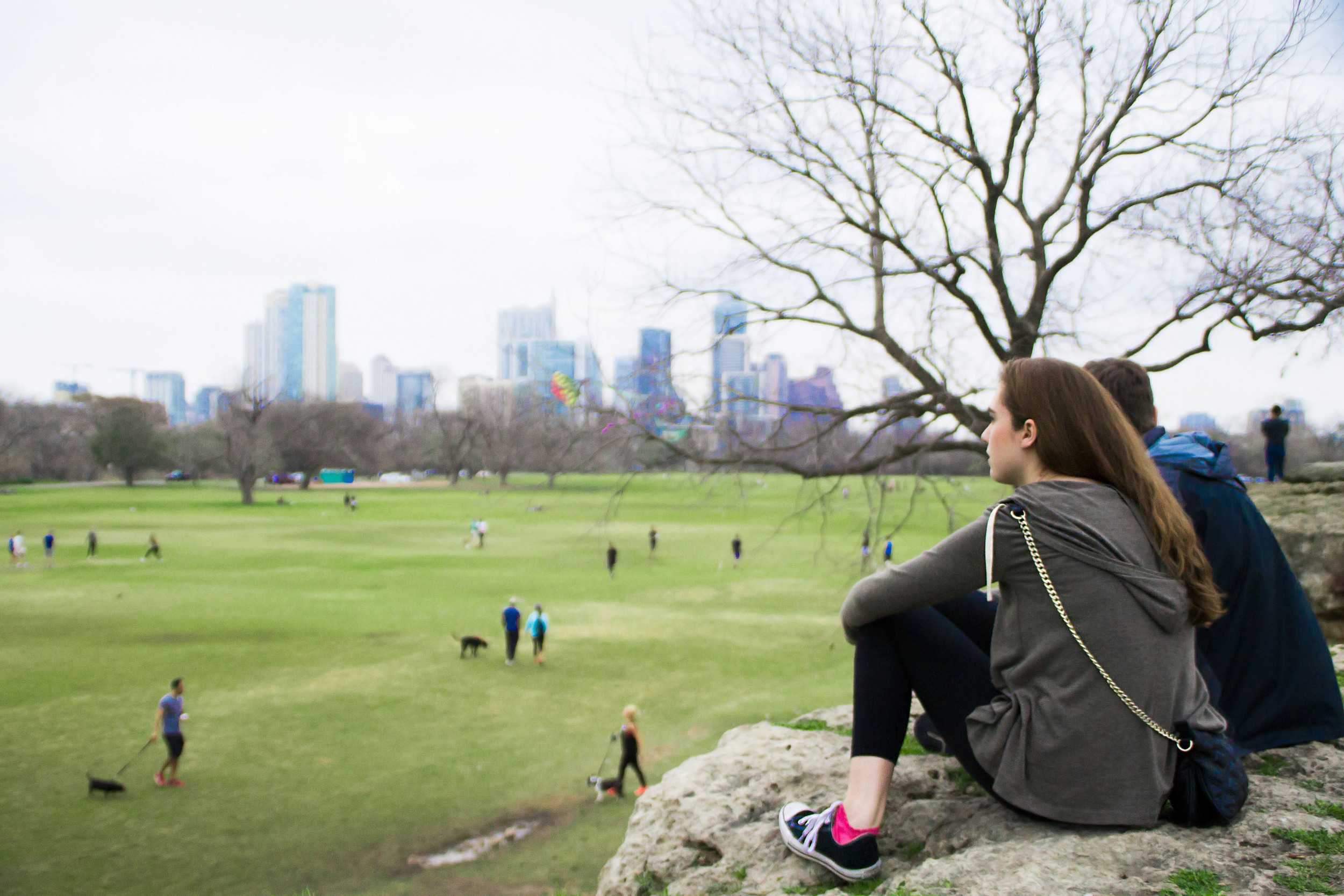  University of Texas at Austin freshmen Savannah Vincent (left) and Aiden Park (right) observe the activities at Zilker Park as Austinites break out of hibernation and embrace the warmth. 