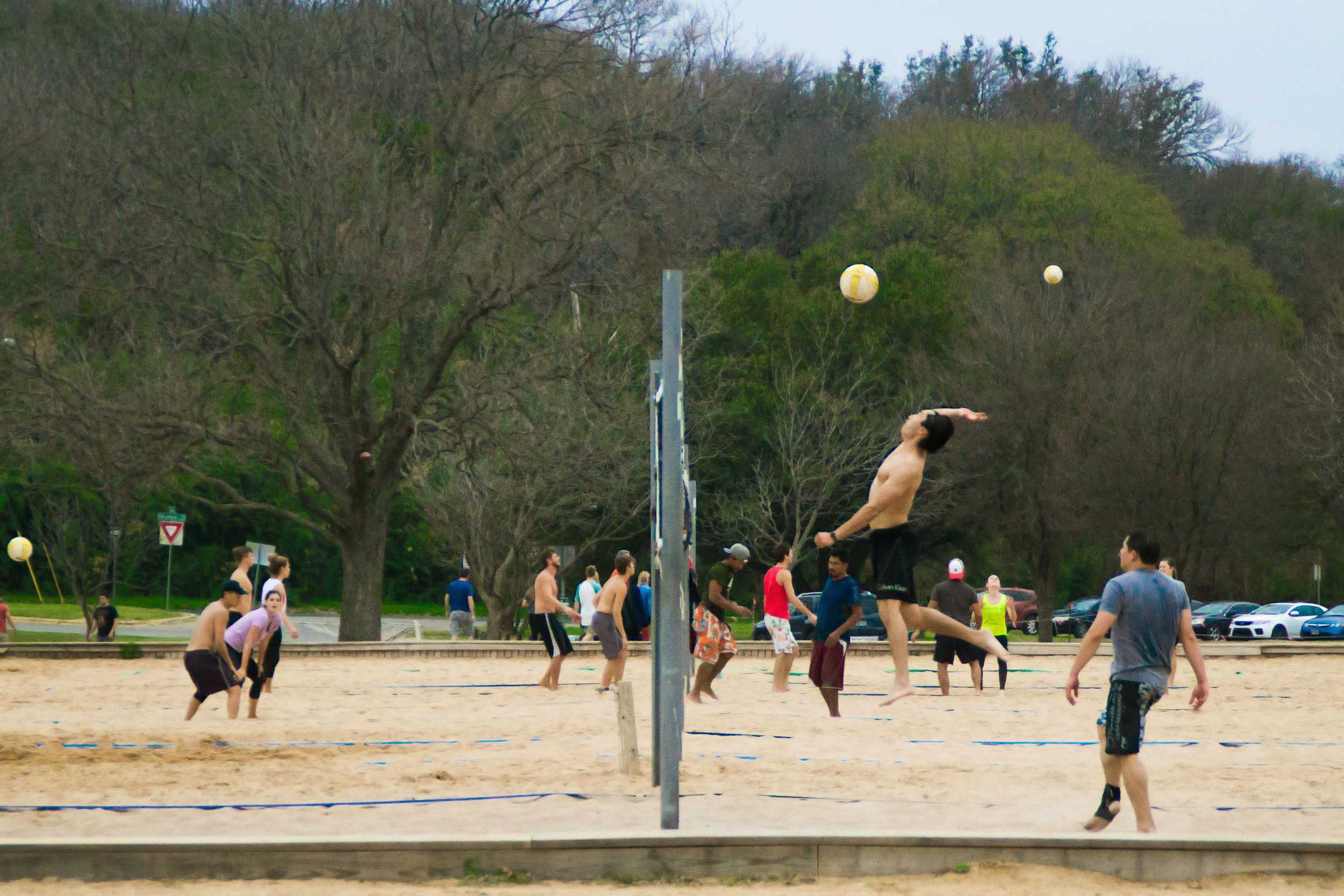  Spring weather brings spring sports— a group of athletes play sand volleyball at Zilker Park. 