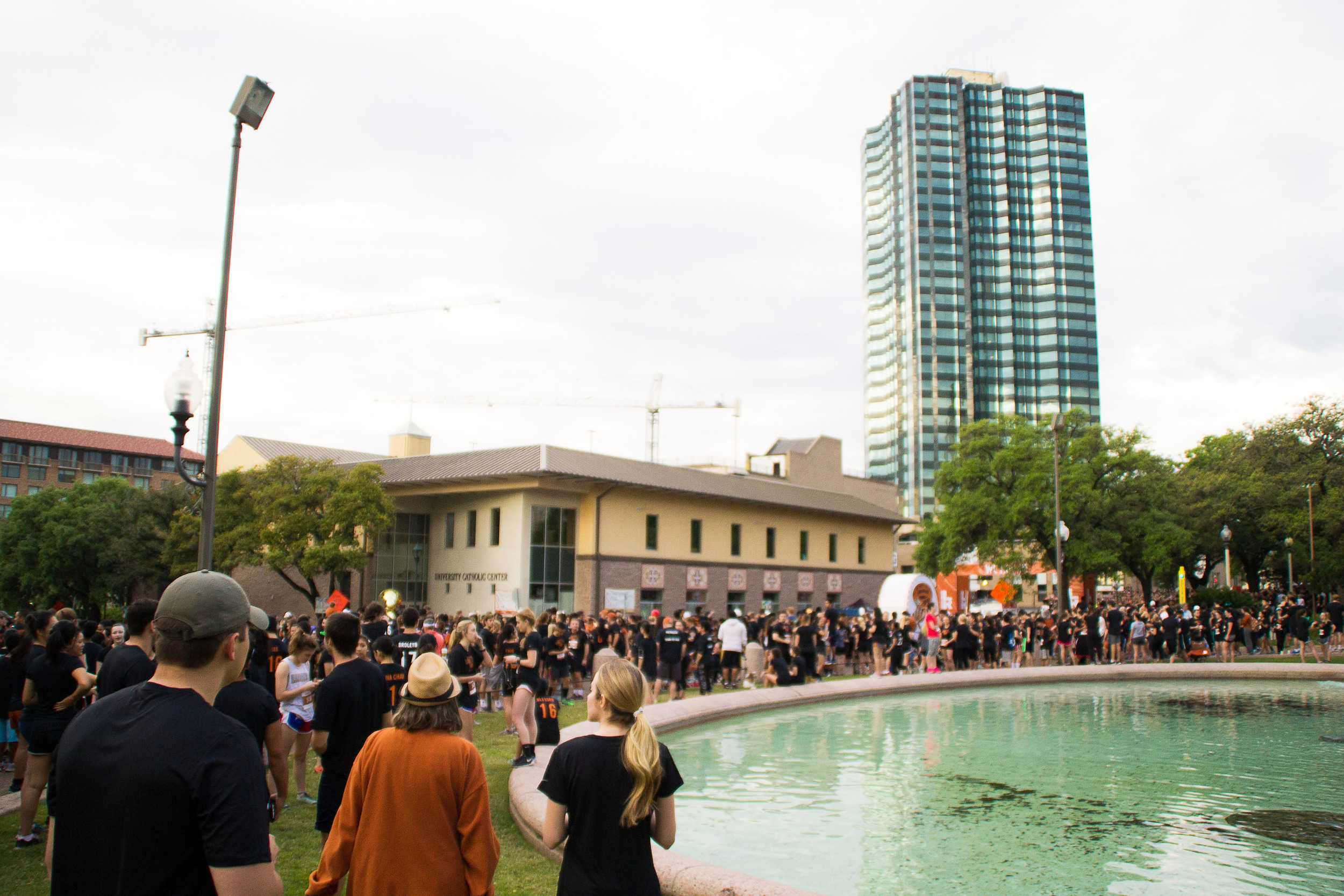  Crowds gather excitedly around the starting off point, just across from the Littlefield Fountain at the south end of the tower. Black and burnt orange tee shirts fill the streets as people of all ages shift to the sidelines to watch the races begin.