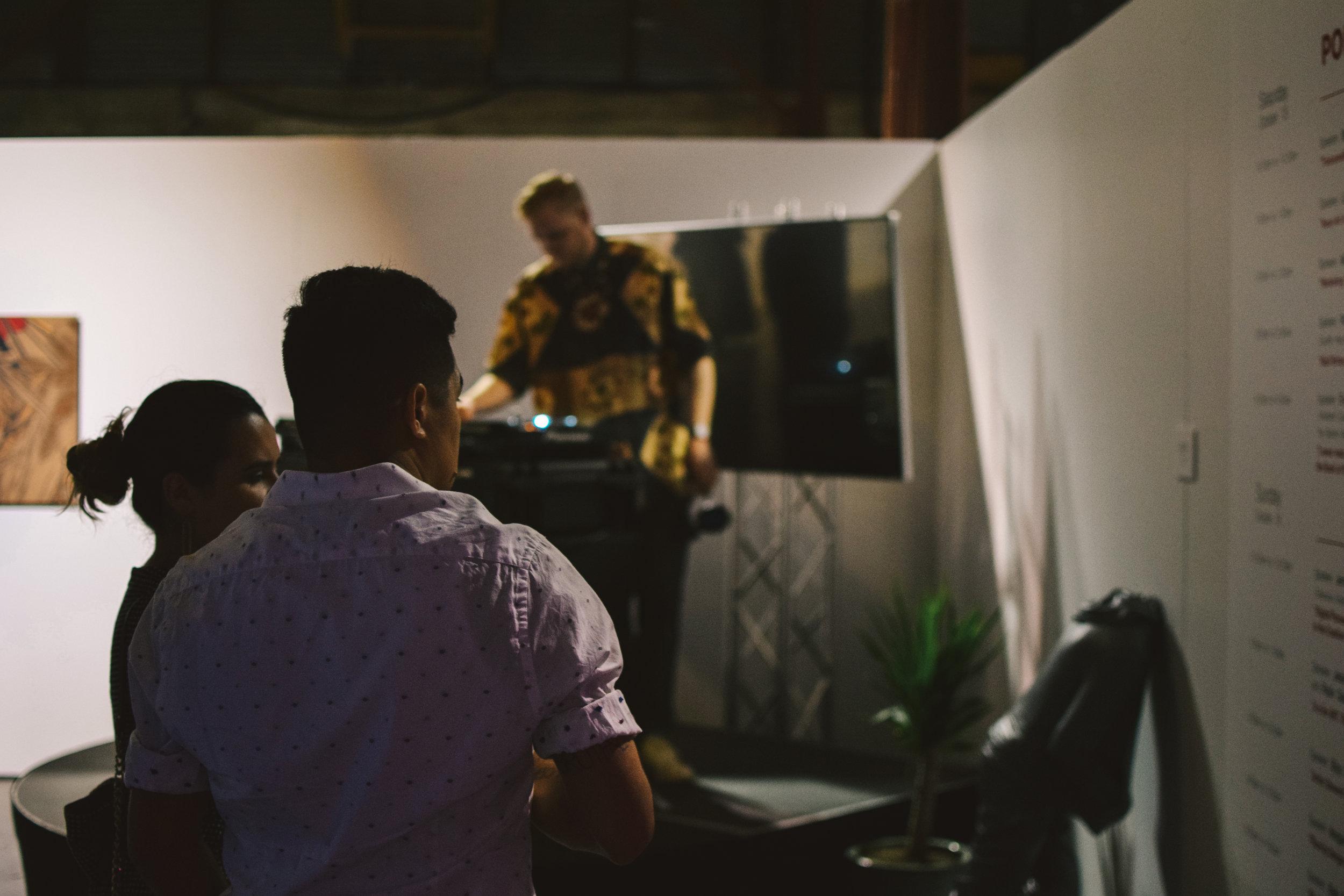   A DJ plays music during the art show.  