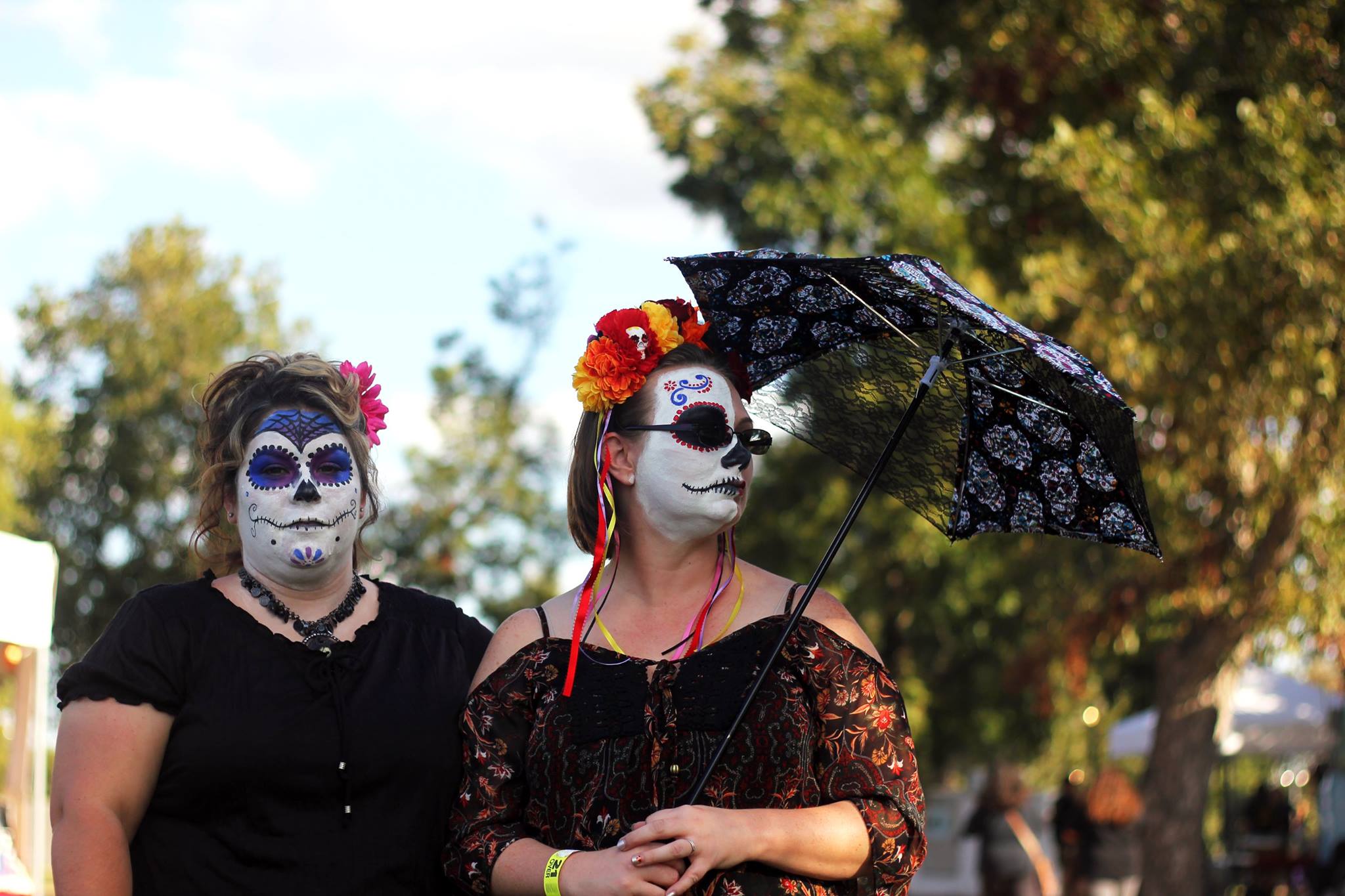   A face painting booth was designated for children and adults to embrace the culture and symbols of the holiday. Two women wear traditional face paint resembling the calavera during the Day of the Dead Music Festival.  