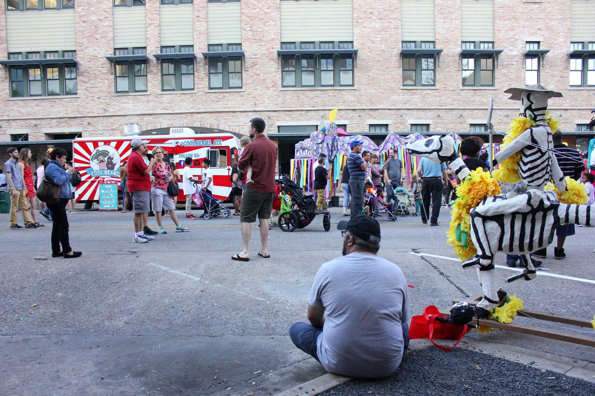   A festival attendee takes a break and watches the crowd.  