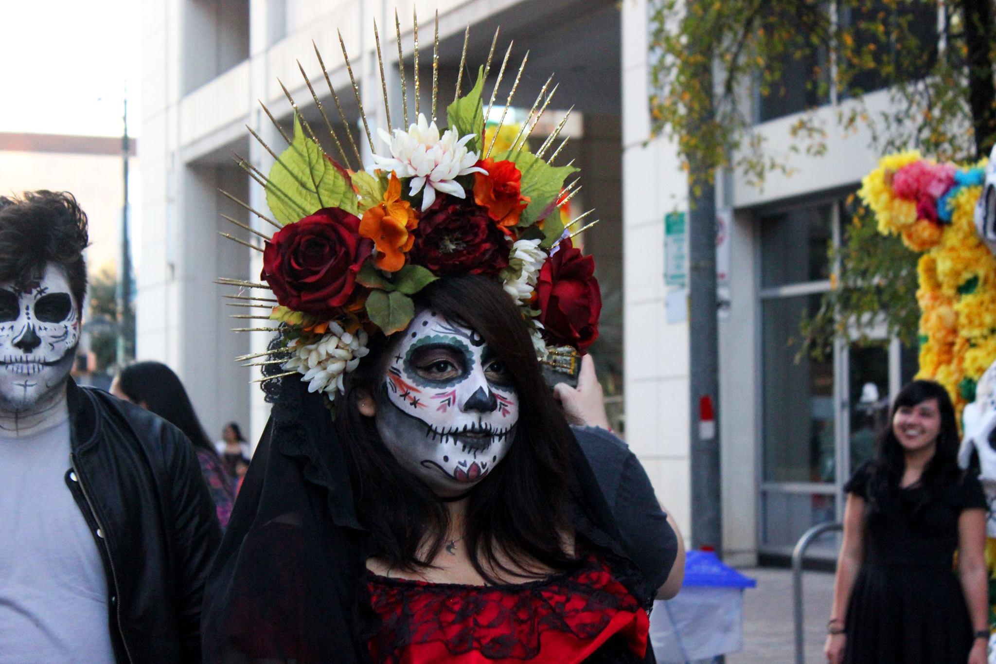   Festival attendee wears a detailed headpiece and face paint.  