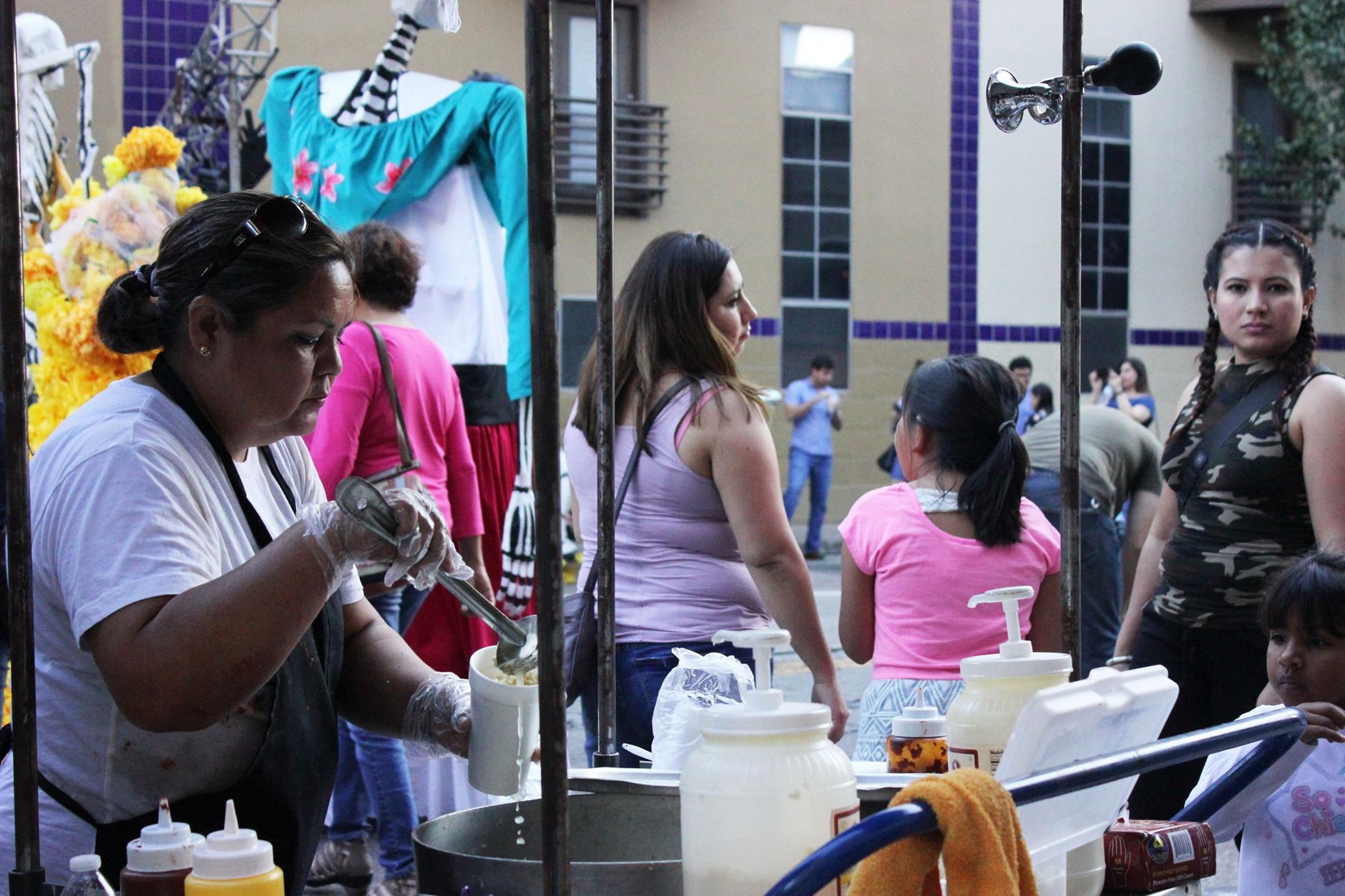   Viva La Vida had a variety of vendors such as Cool Beans, Vaquero Taquero, and Veracruz All Natural. A worker from Hay Elotes prepares a corn in a cup for a customer.   