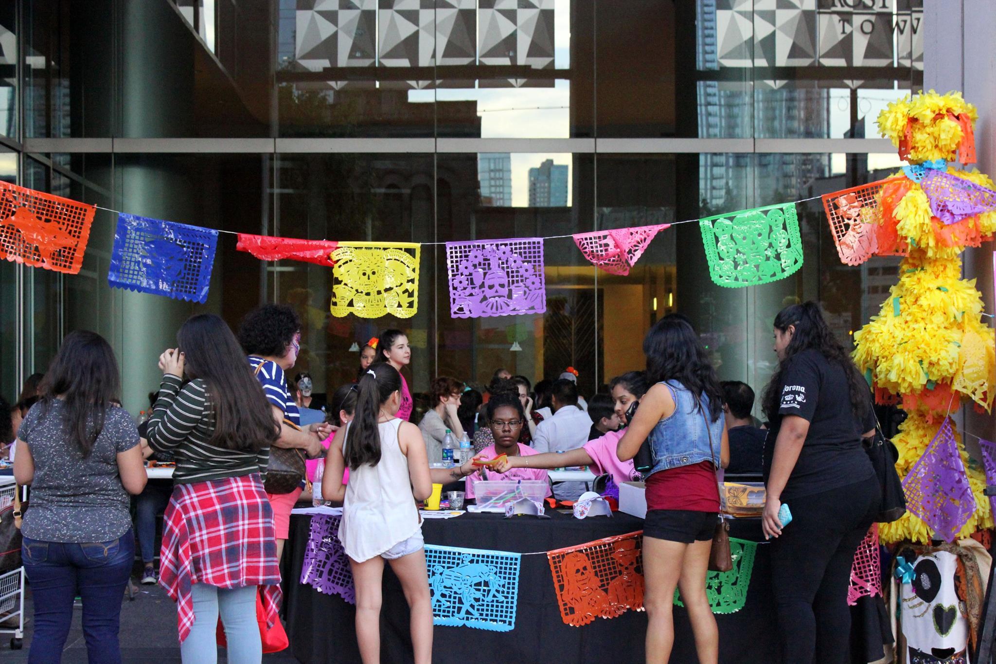   At the Frost Bank Tower Plaza children and families gather art supplies to participate in arts and crafts. Parade props were as well held here to give the public a chance to take pictures.   