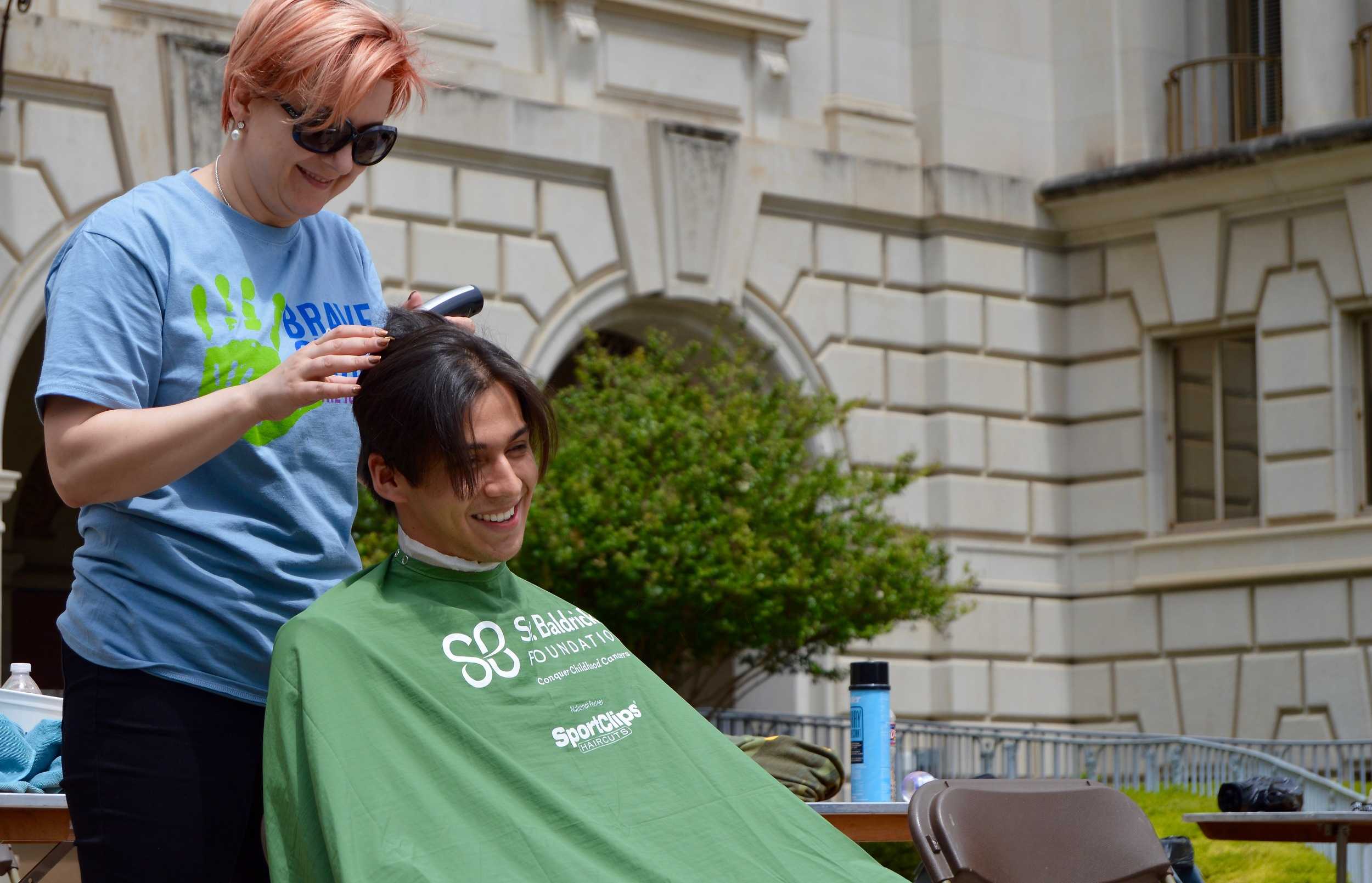   Abraham Flores getting his hair shaven off.   