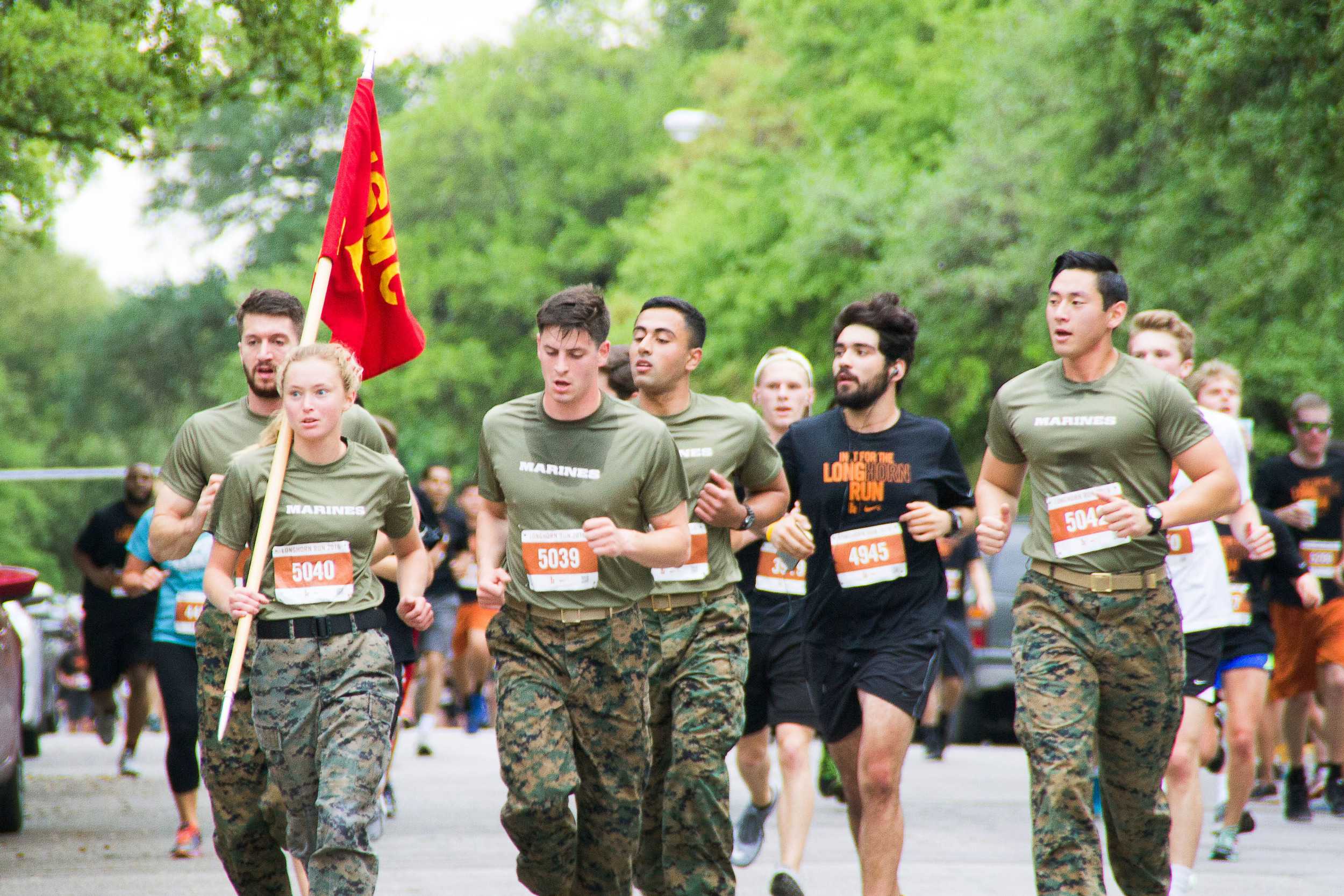  Members of the US Marine Corps run in their uniforms at the last leg of the race, displaying pride for their country. 