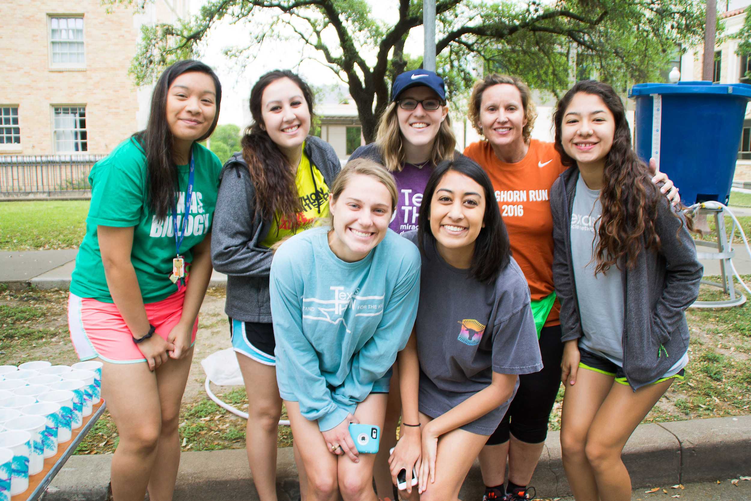  At the last water station until the finish line, volunteers gather and pose just before the wave of runners comes by. 