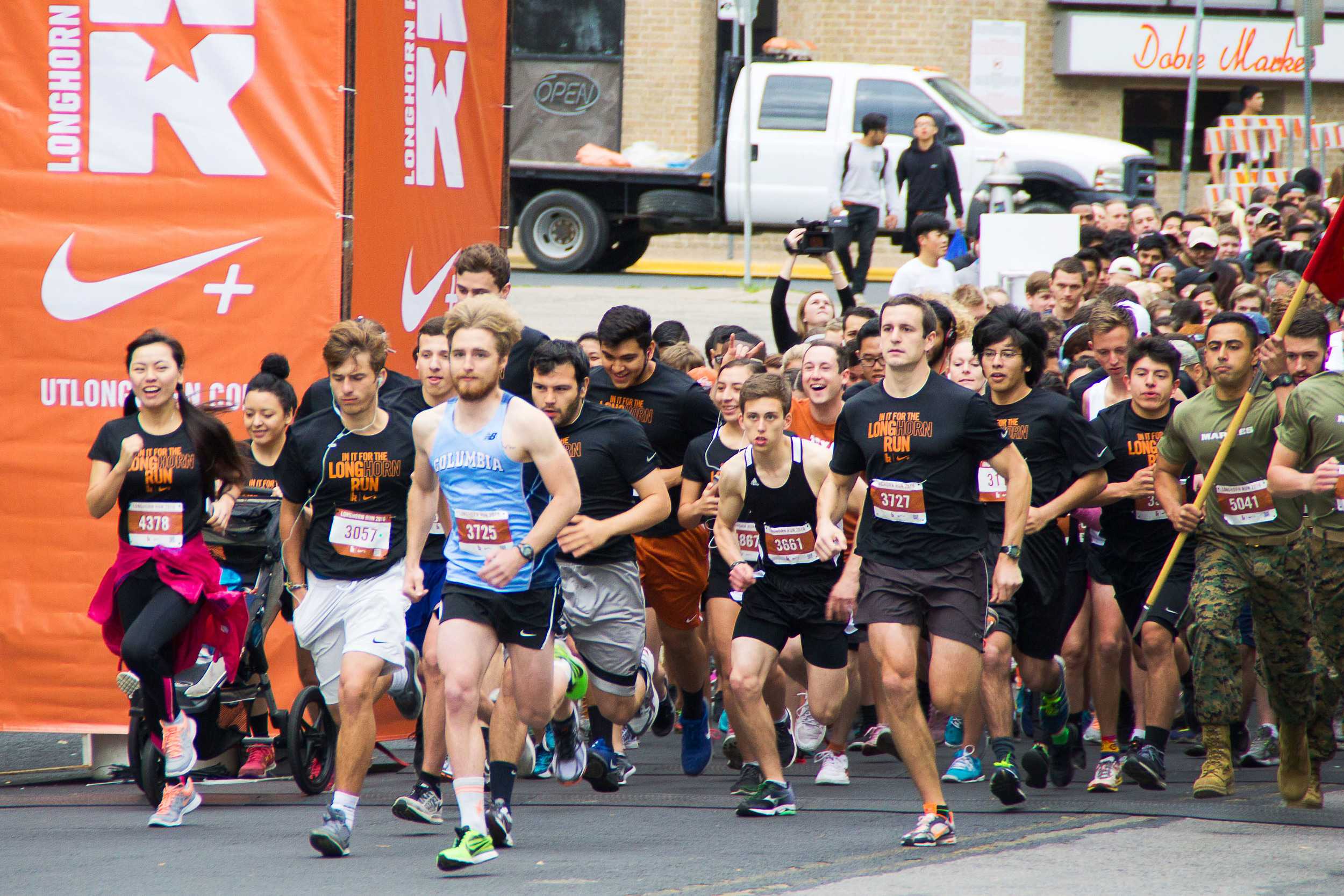  On your mark, get set, go! The front line of runners sprints upon the sound of the cannonfire, kicking off the 5K race. 