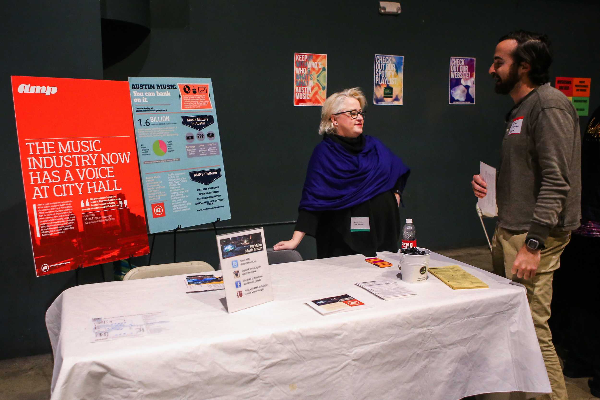   A representative from Amp talks with a local musician at Austin Music Foundation’s “Feel the Love” Expo on Feb. 10, 2016.   