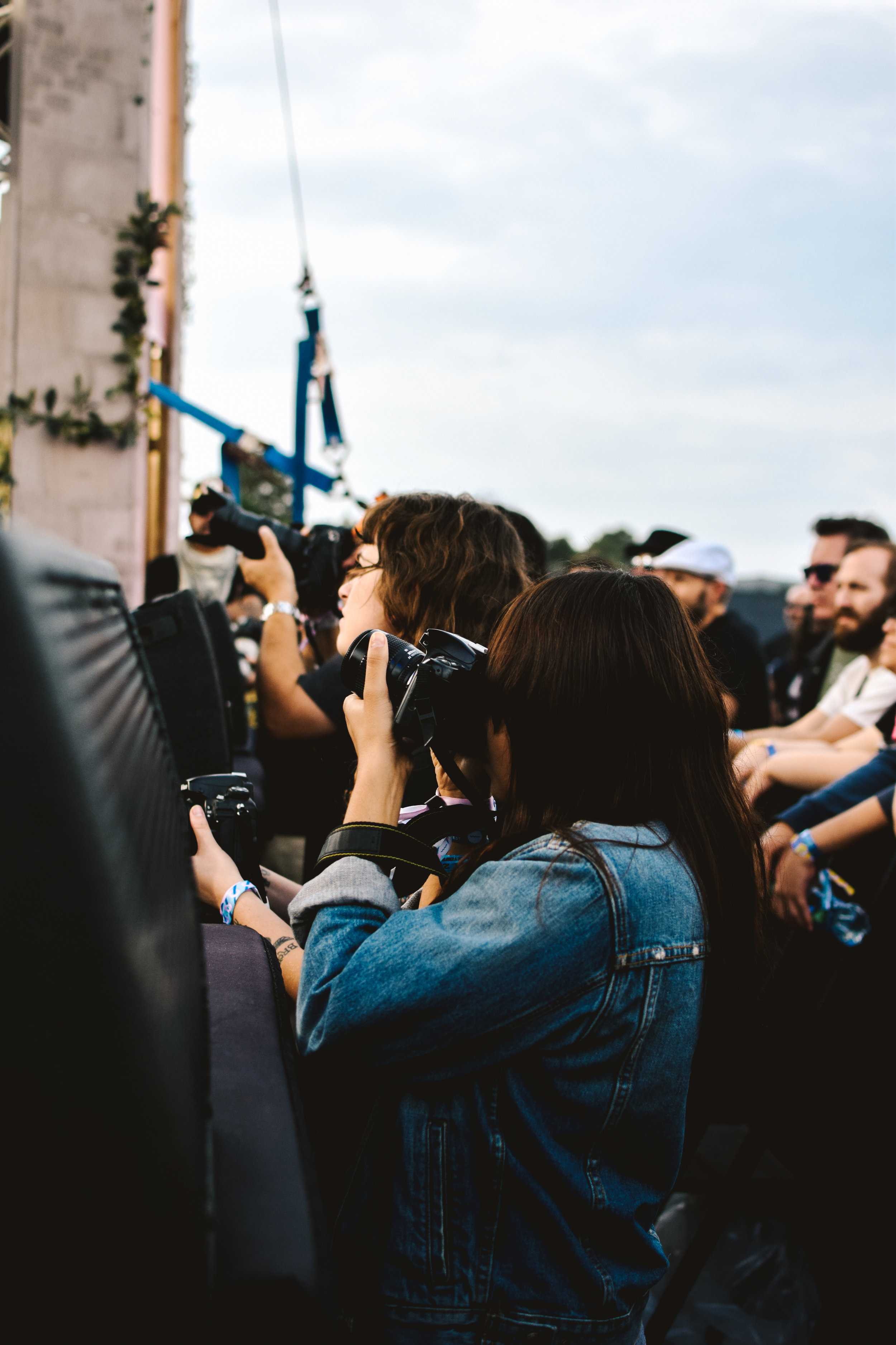   Photographers get ready to shoot the next performance in the photo pit.  