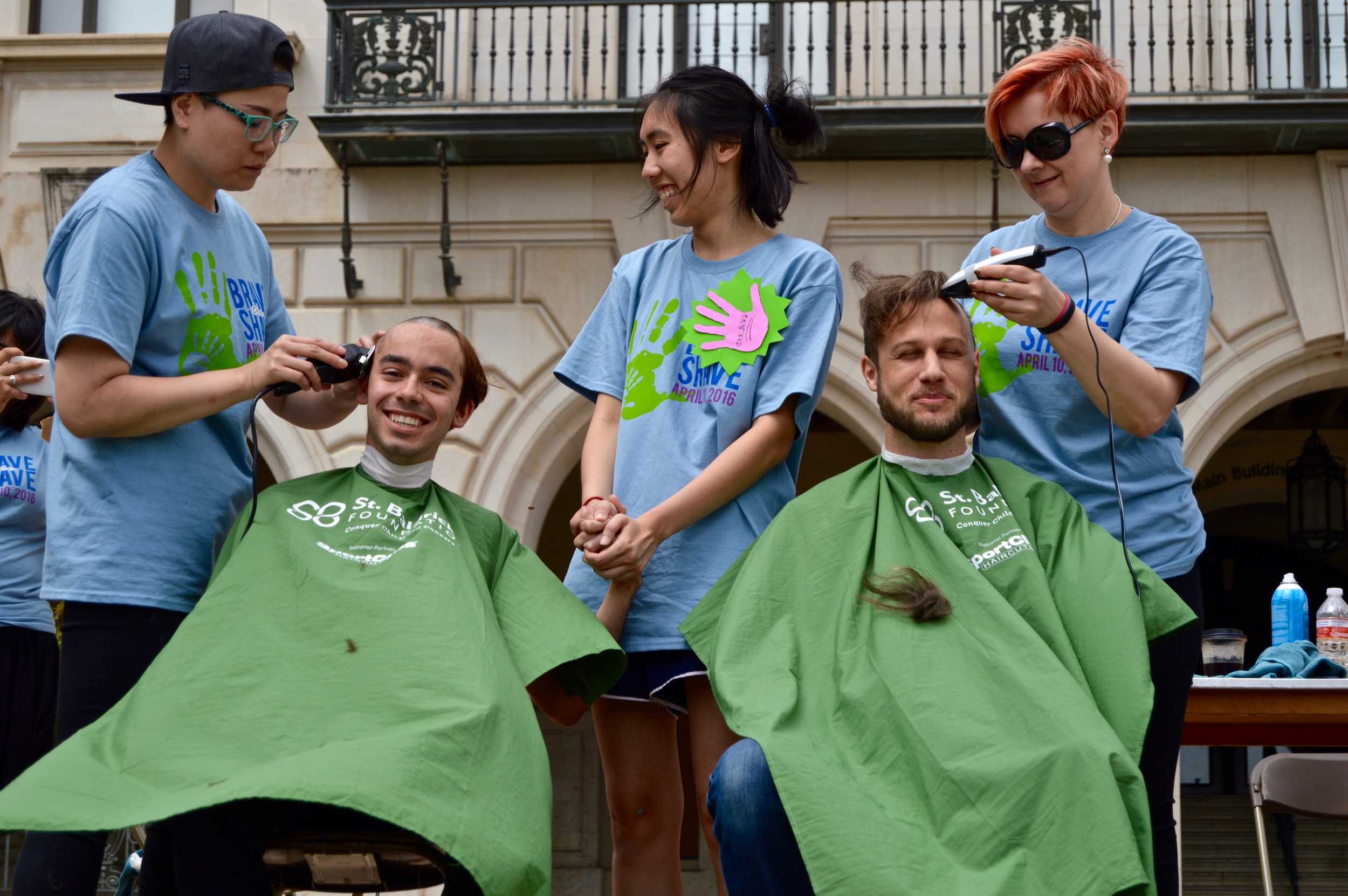   David Aguirre getting his hair shaven off.   