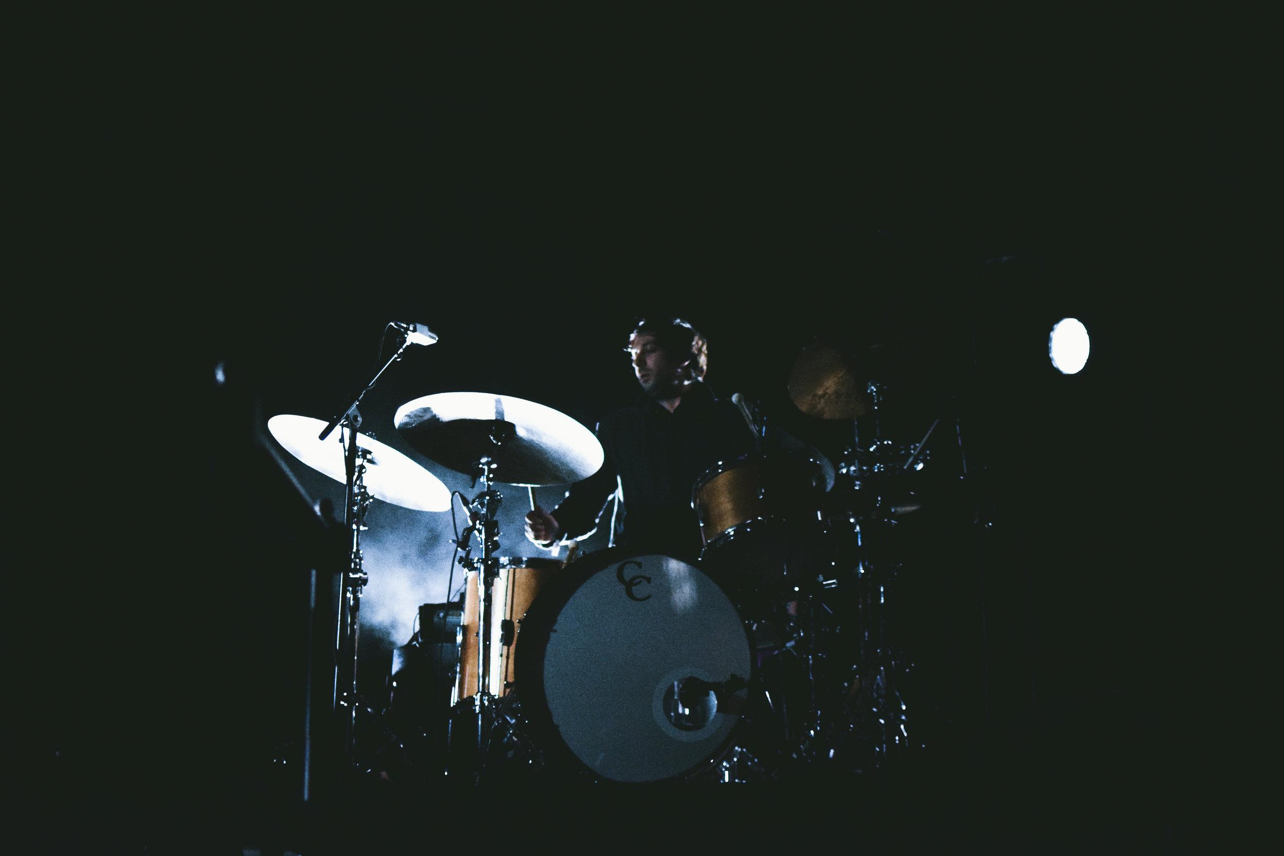   Drummer of Beach House sets up his drum set for the performance.  