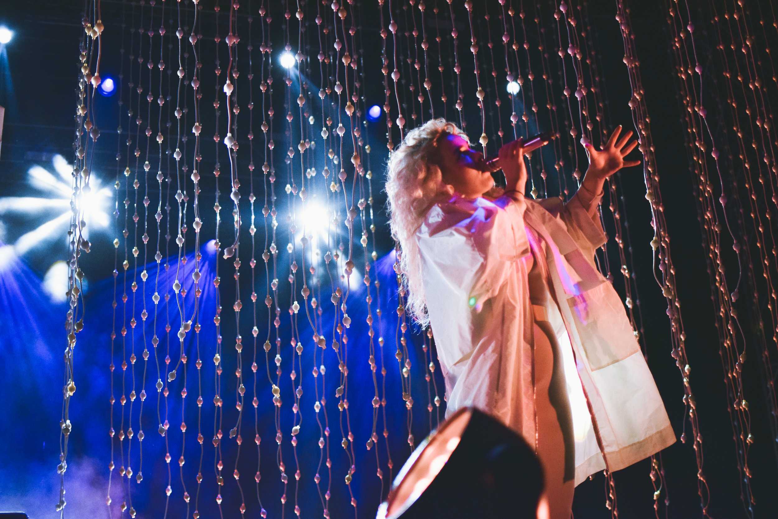   Megan James of Purity Ring sings to the crowd.  