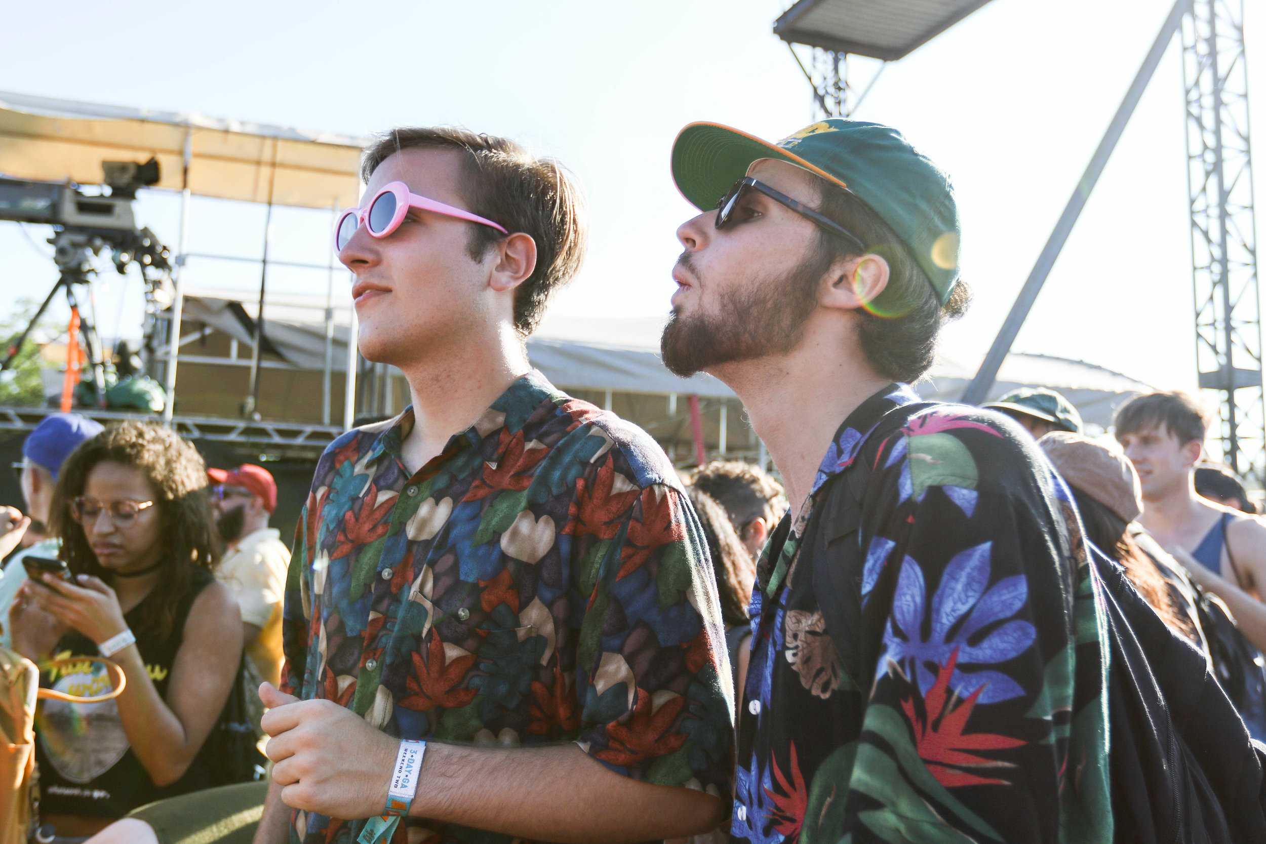   Two friends sport fashionable sunglasses to combat the Austin sun.  