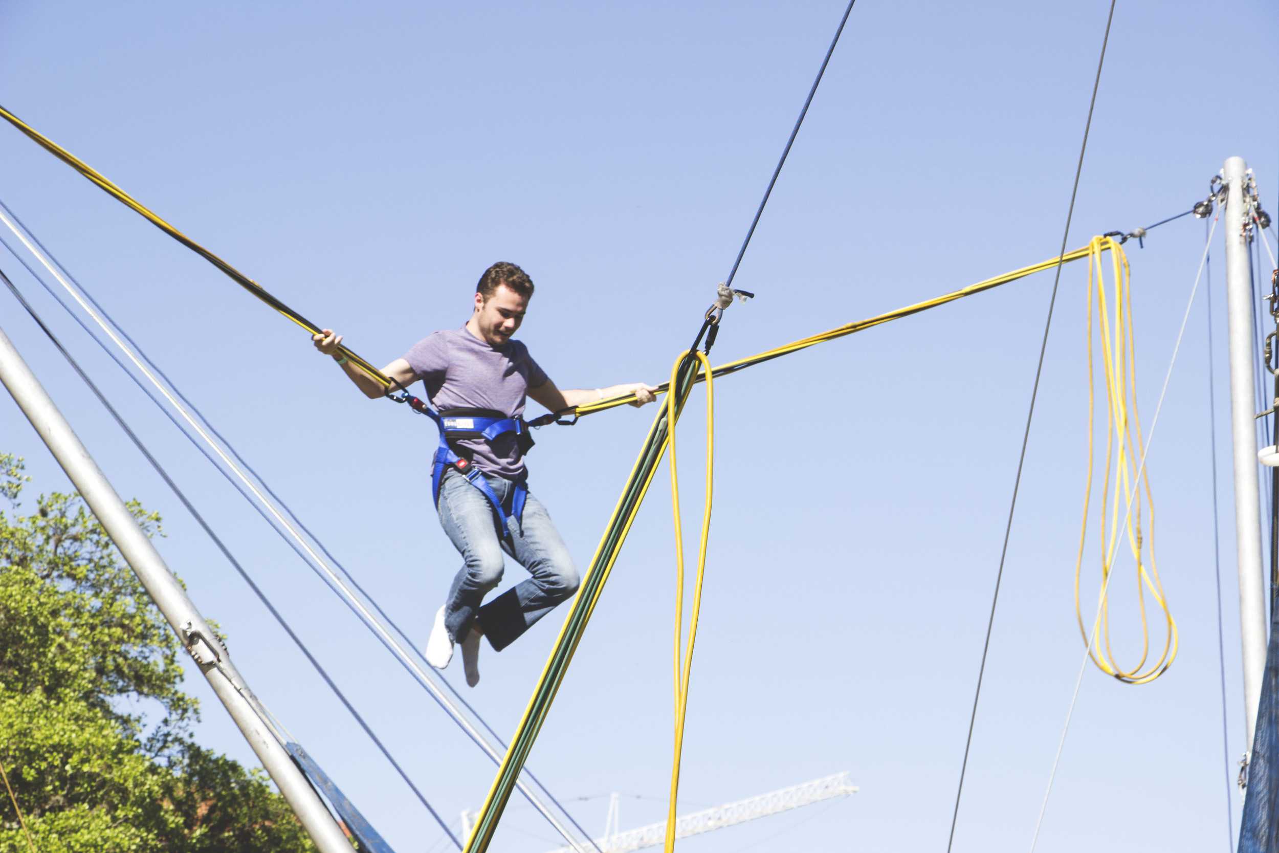   A festival attendee bungee jumps.  