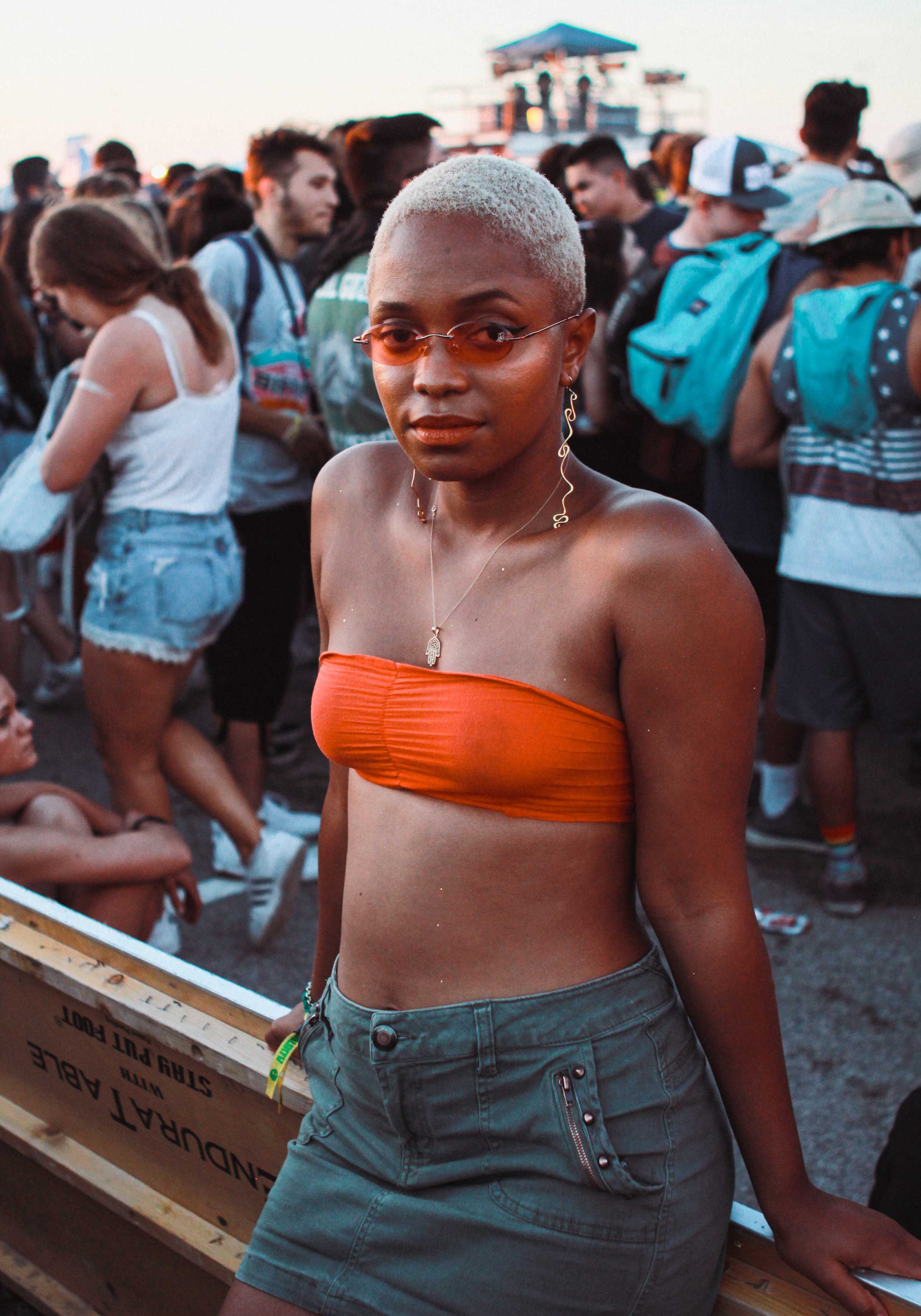   With a smooth blond cut and rosy glasses, this audience member patiently awaits the next performance.   