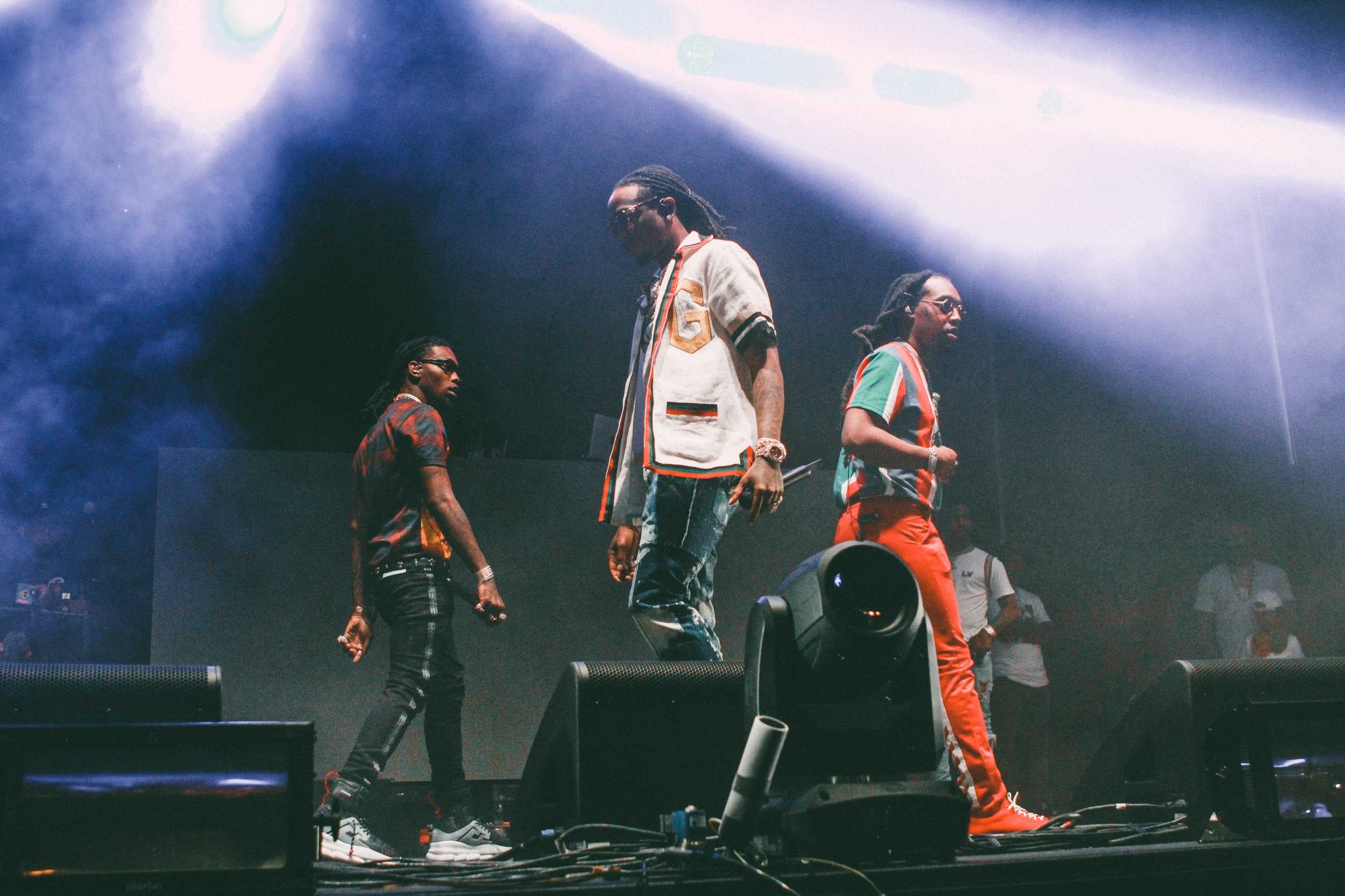   Migos walks around stage as their set begins.  