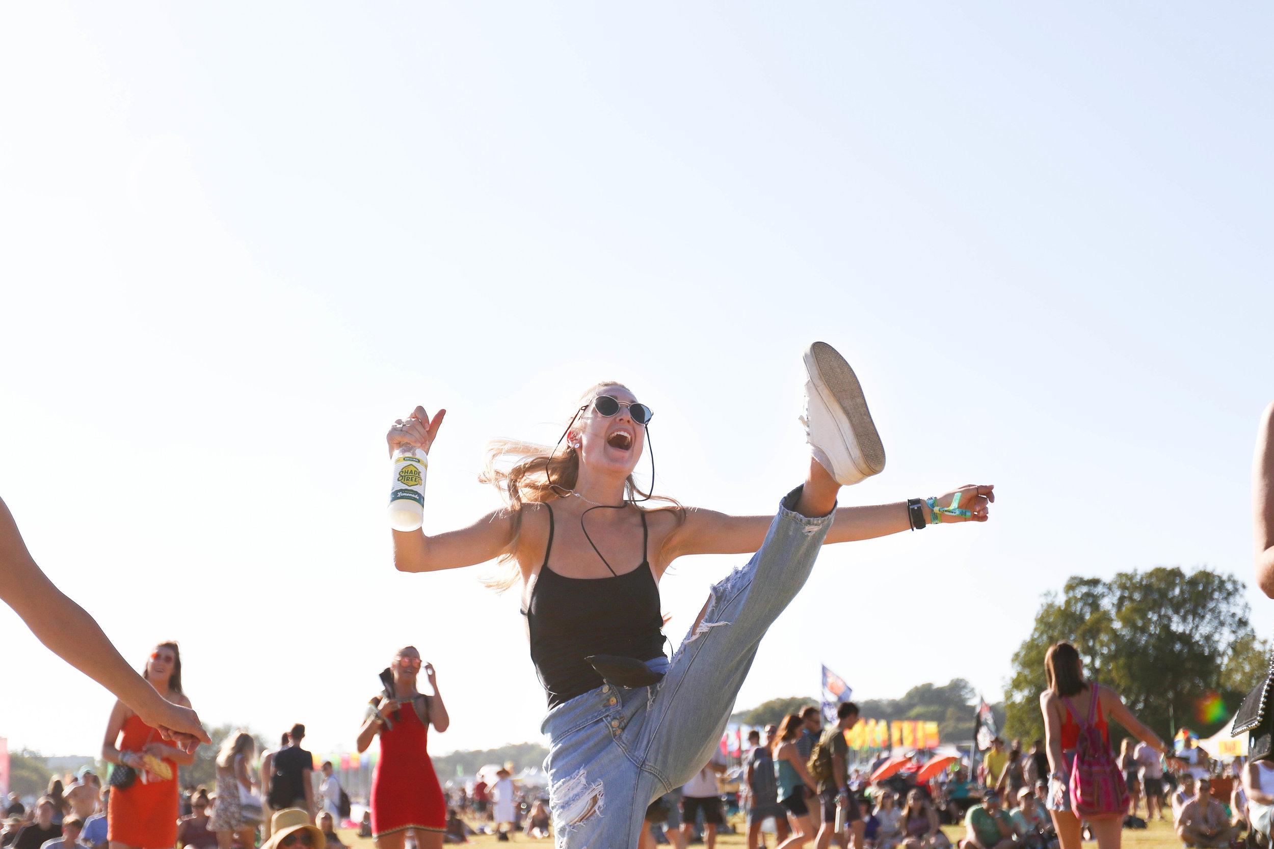   Festival attendee executes an impressive high kick while dancing.  