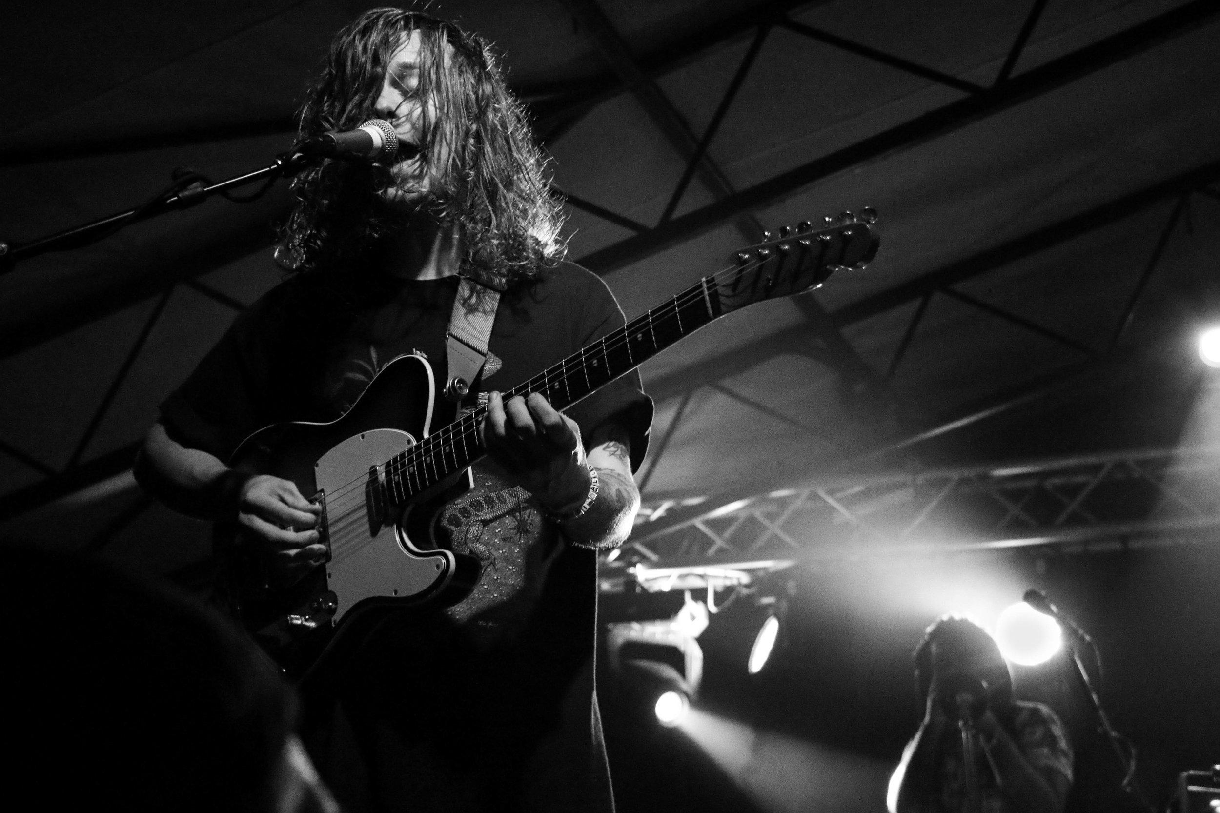   Nathan Stocker plays his guitar with energy and enthusiasm.  