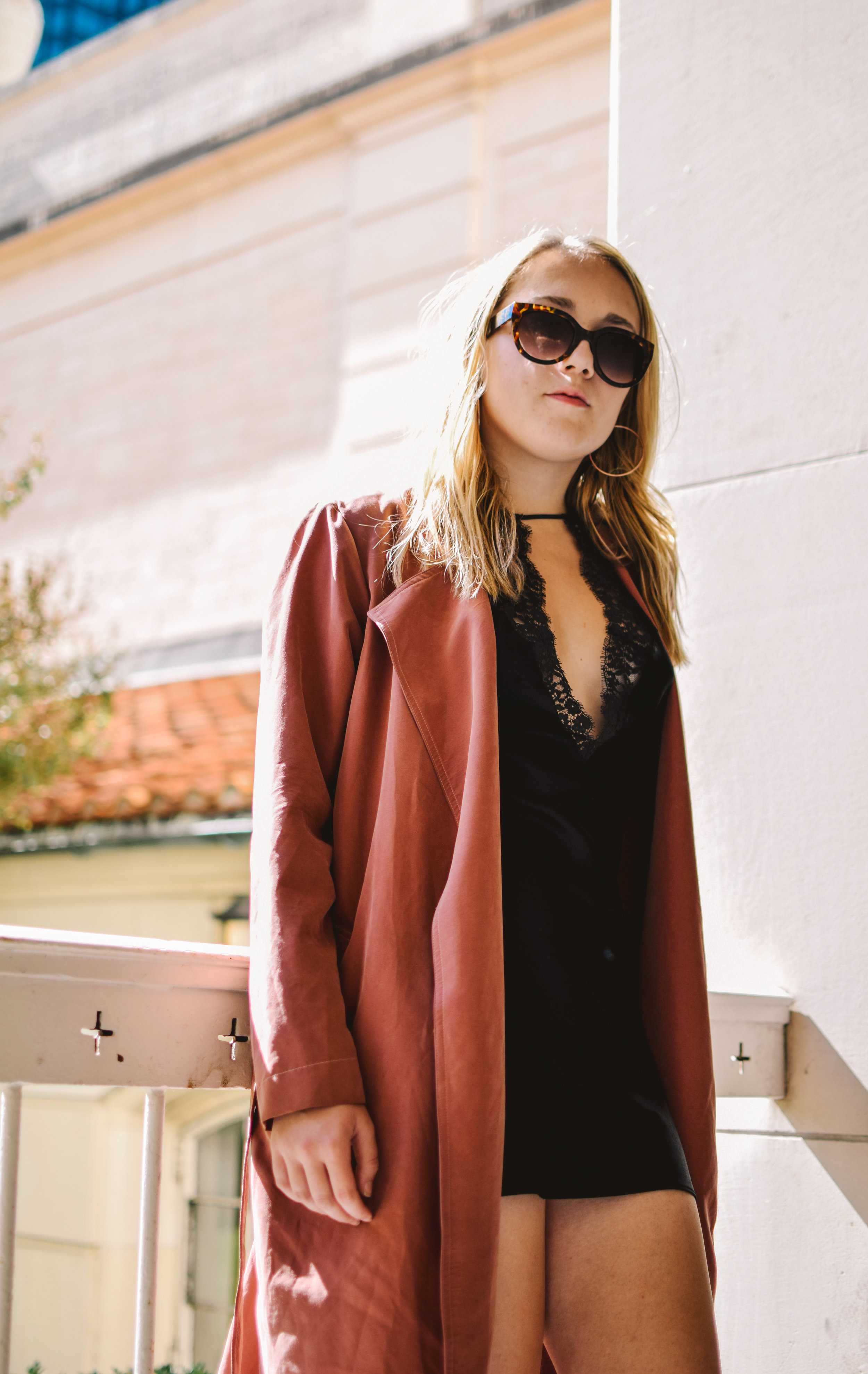   Model Avery Long wears a black slip under a pink duster coat. Styled by Kristina Nguyen and Avery Long.  