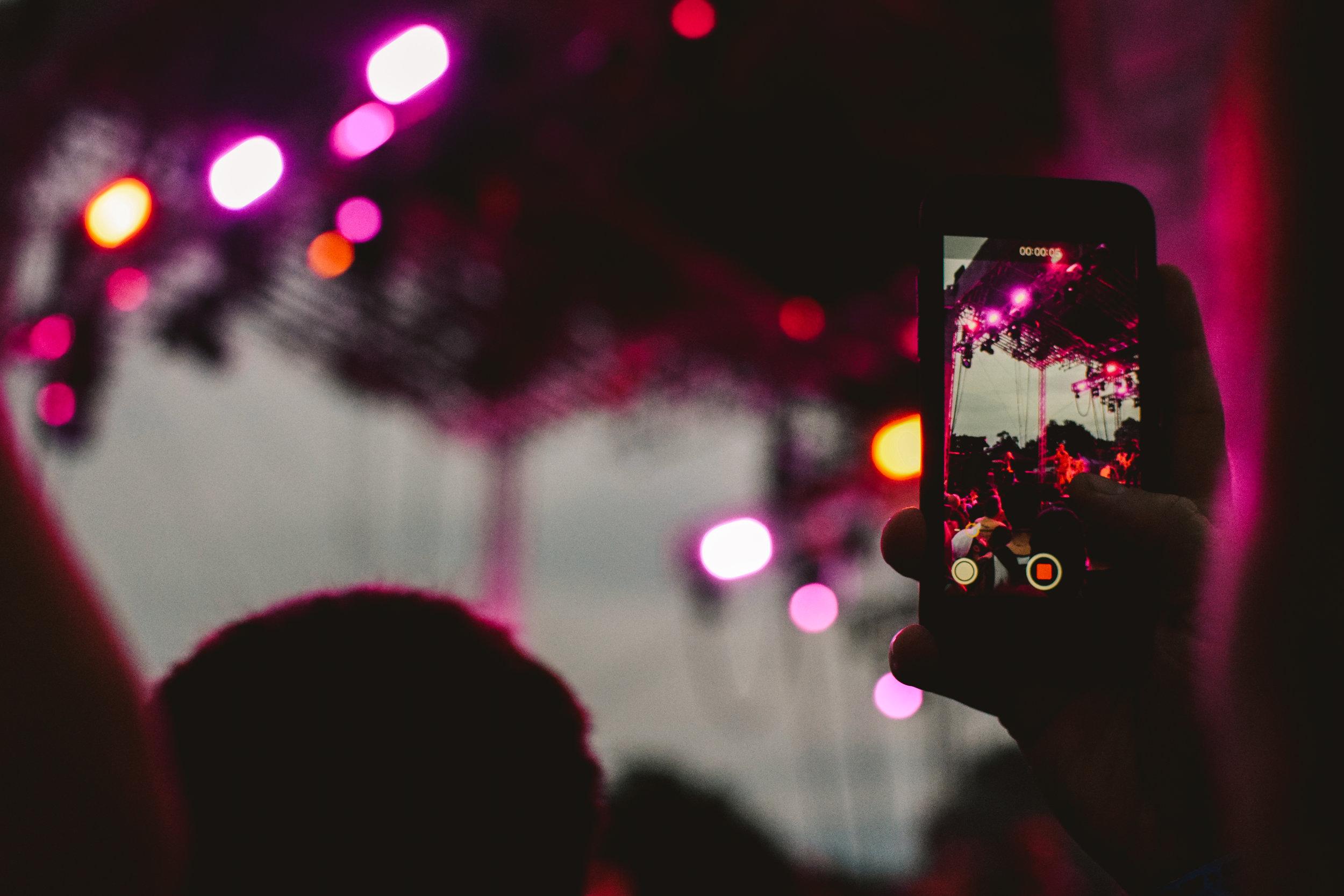   Attendee records the Deerhunter performance.  