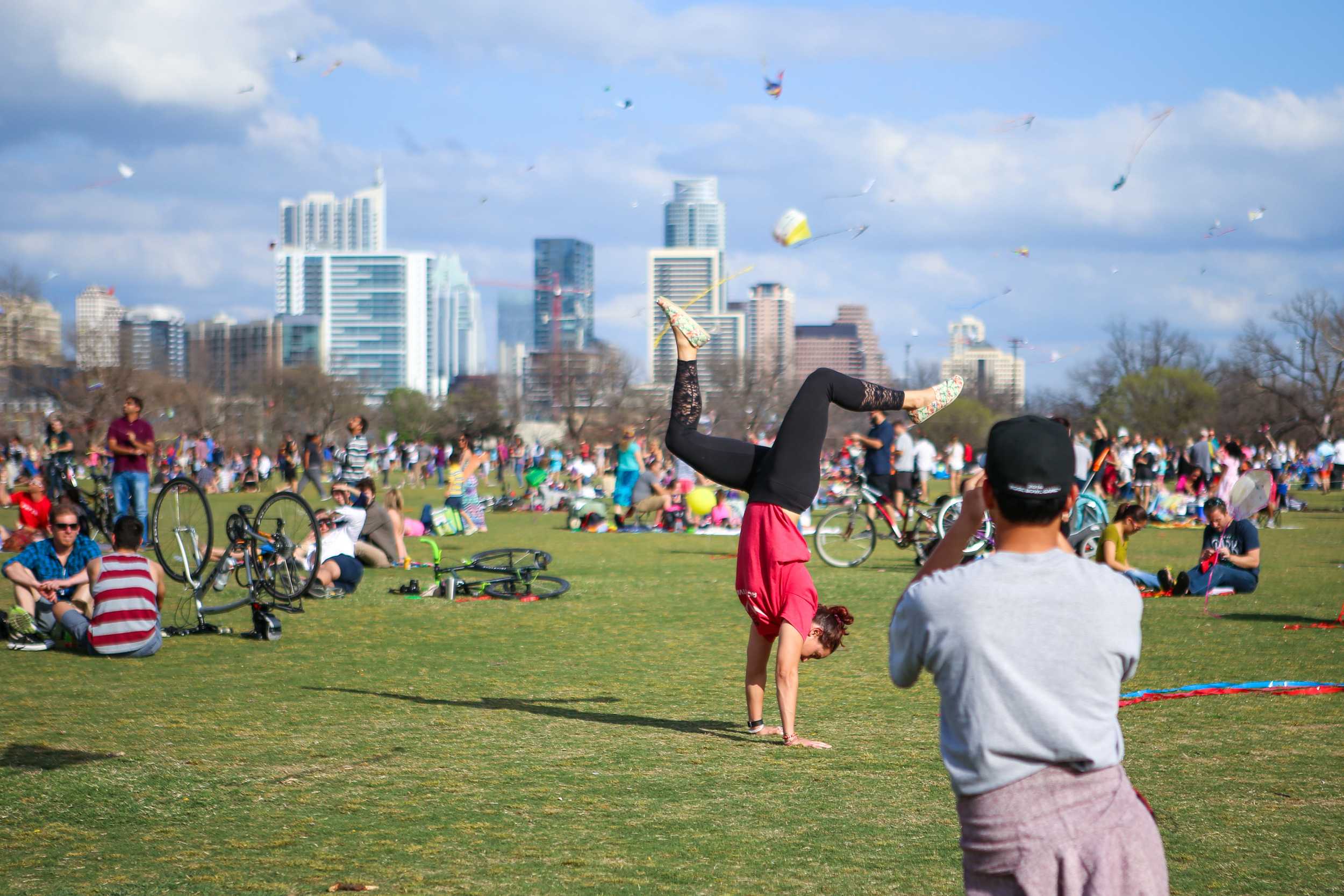  The Austin skyline was filled with colorful kites, making an idyllic background for this woman's pose. 