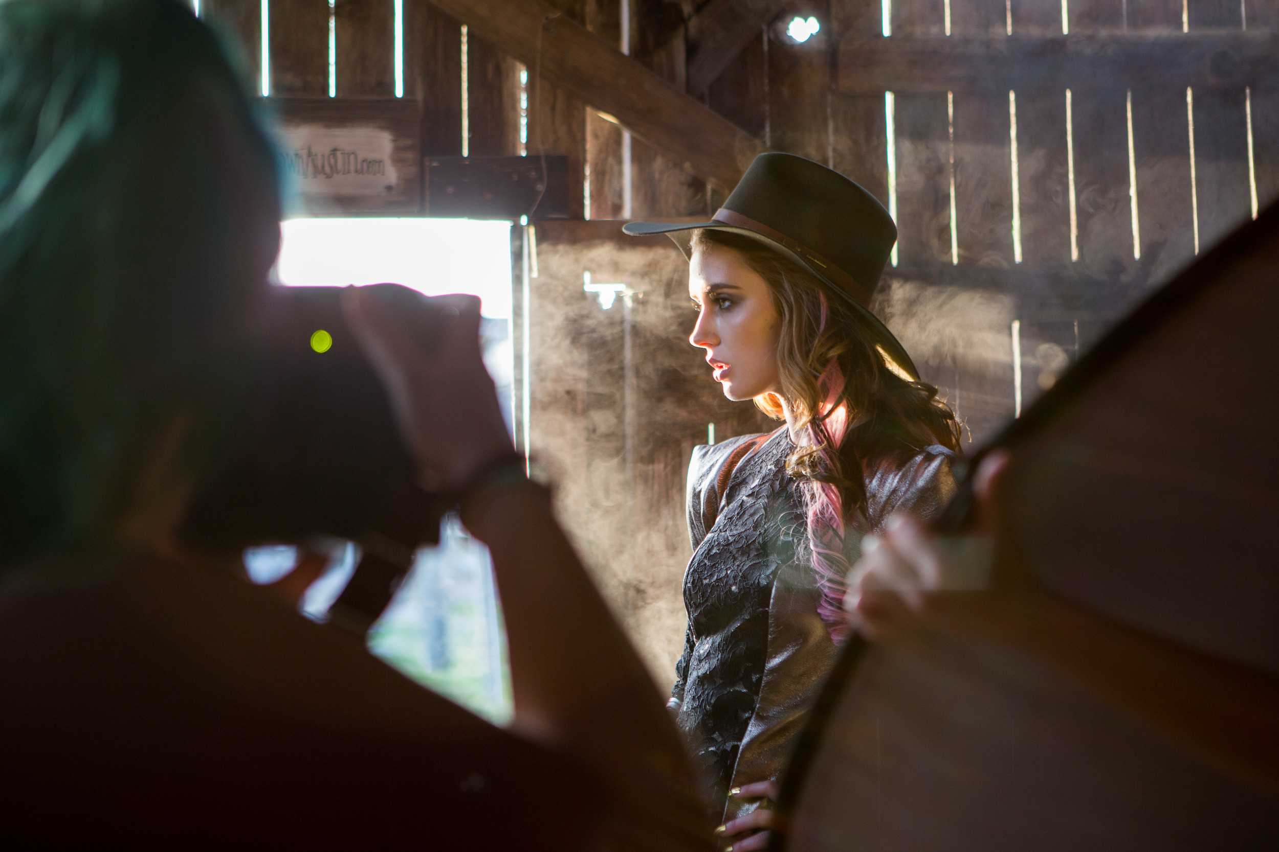   Photographer Nico Nordström captures model Anna Cash as fog bleeds seeps the wooden wall behind her.  