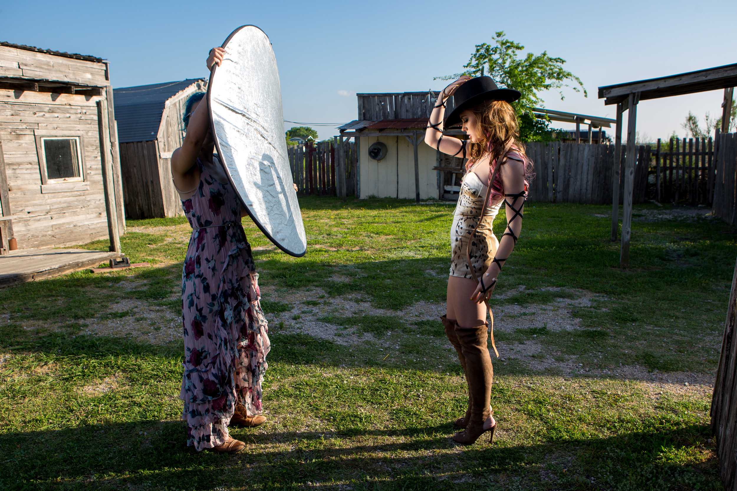   Reflective light is projected across model Anna Cash to alter the lighting in the photos about to be taken of her.   