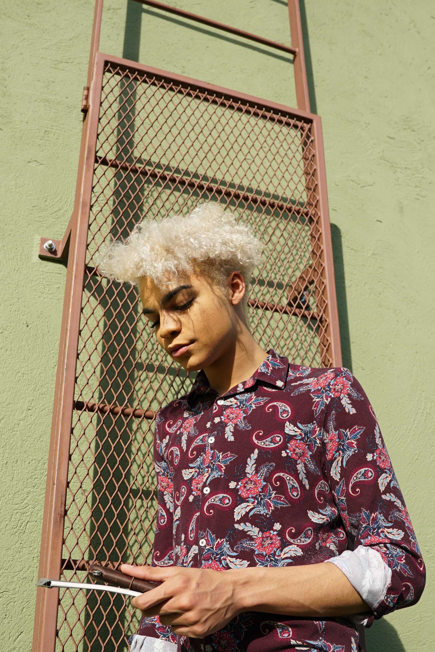   Lewis wears a bright paisley button-down suitable for class and work.  