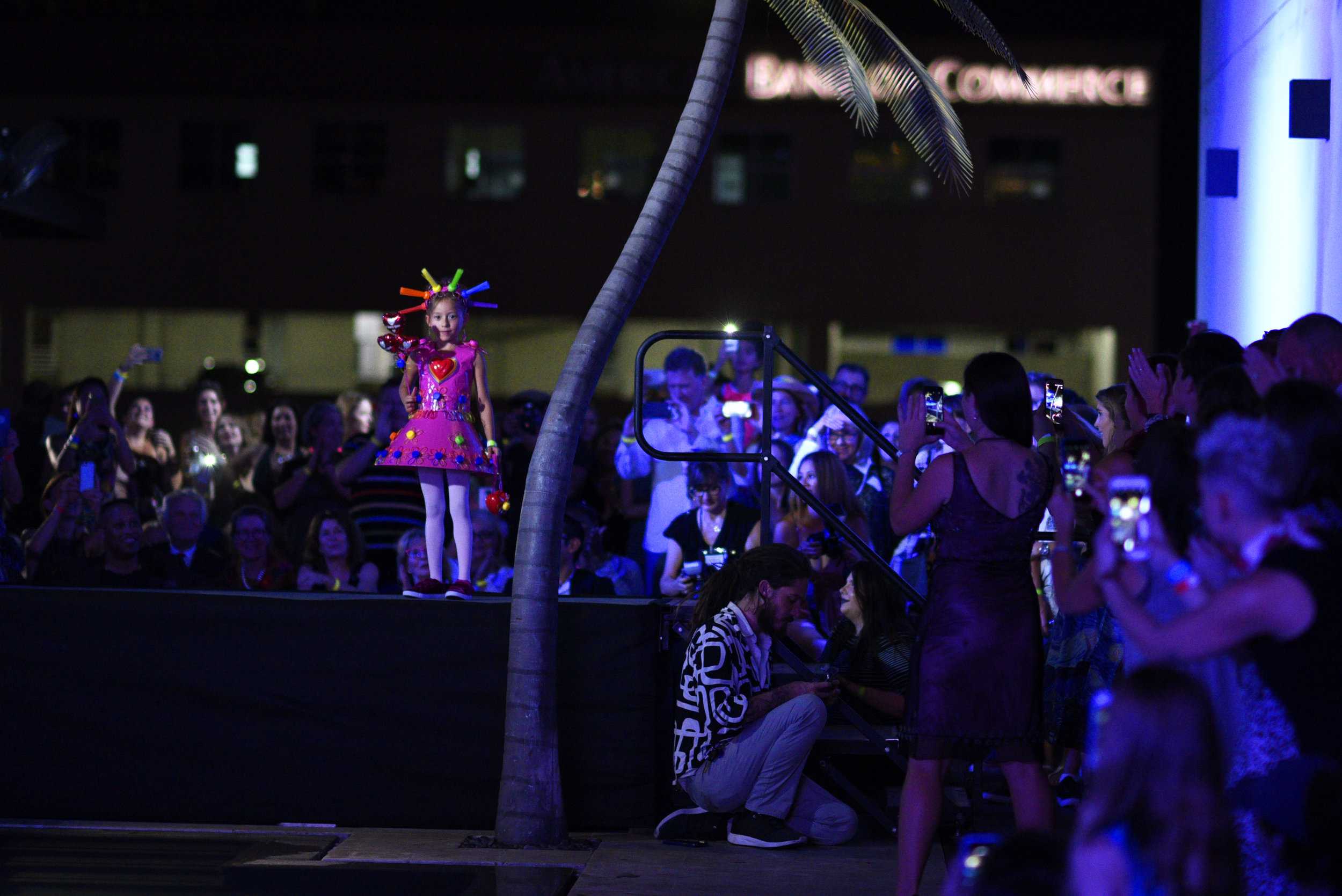   The youngest model in the show poses in front of the judges.     