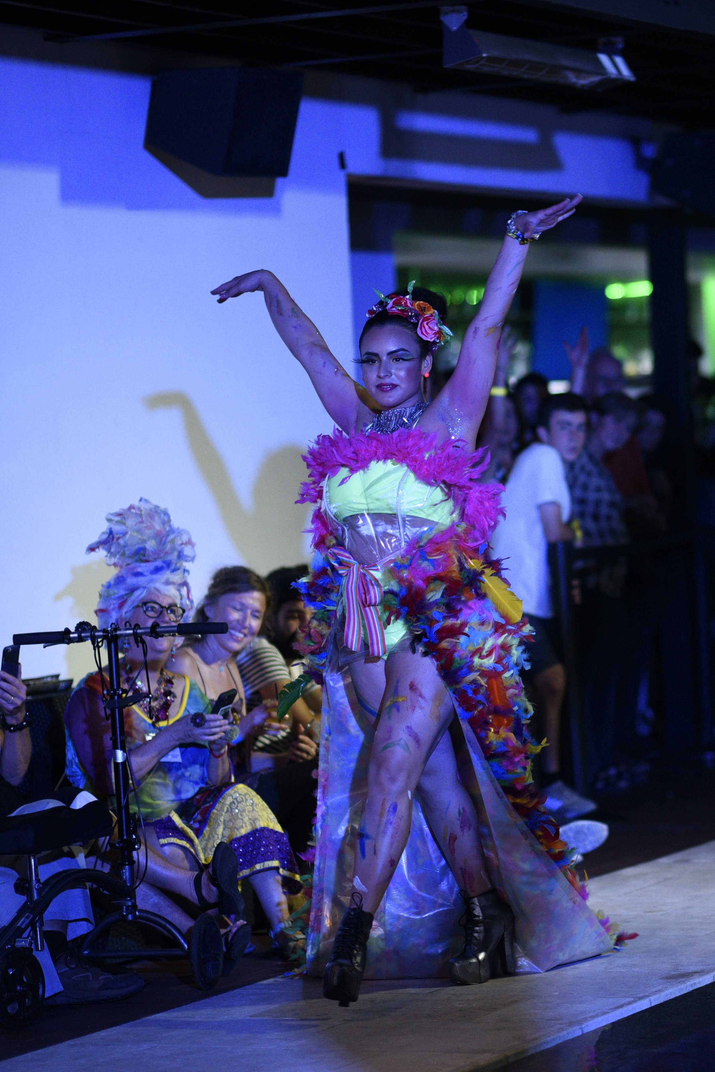   Model raises her arms showing off her outfit.   