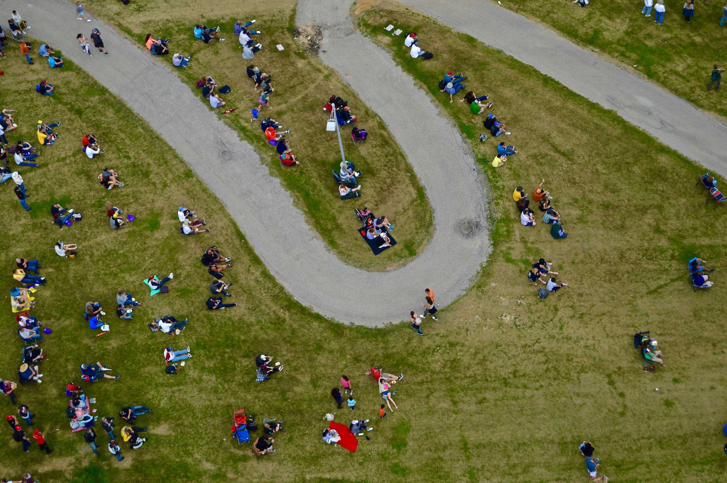   Fans without a seat sit on the lawn at the 2016 Moto GP, the wildest motorcycle racing in the world.    Photo by Alejandra Martinez  