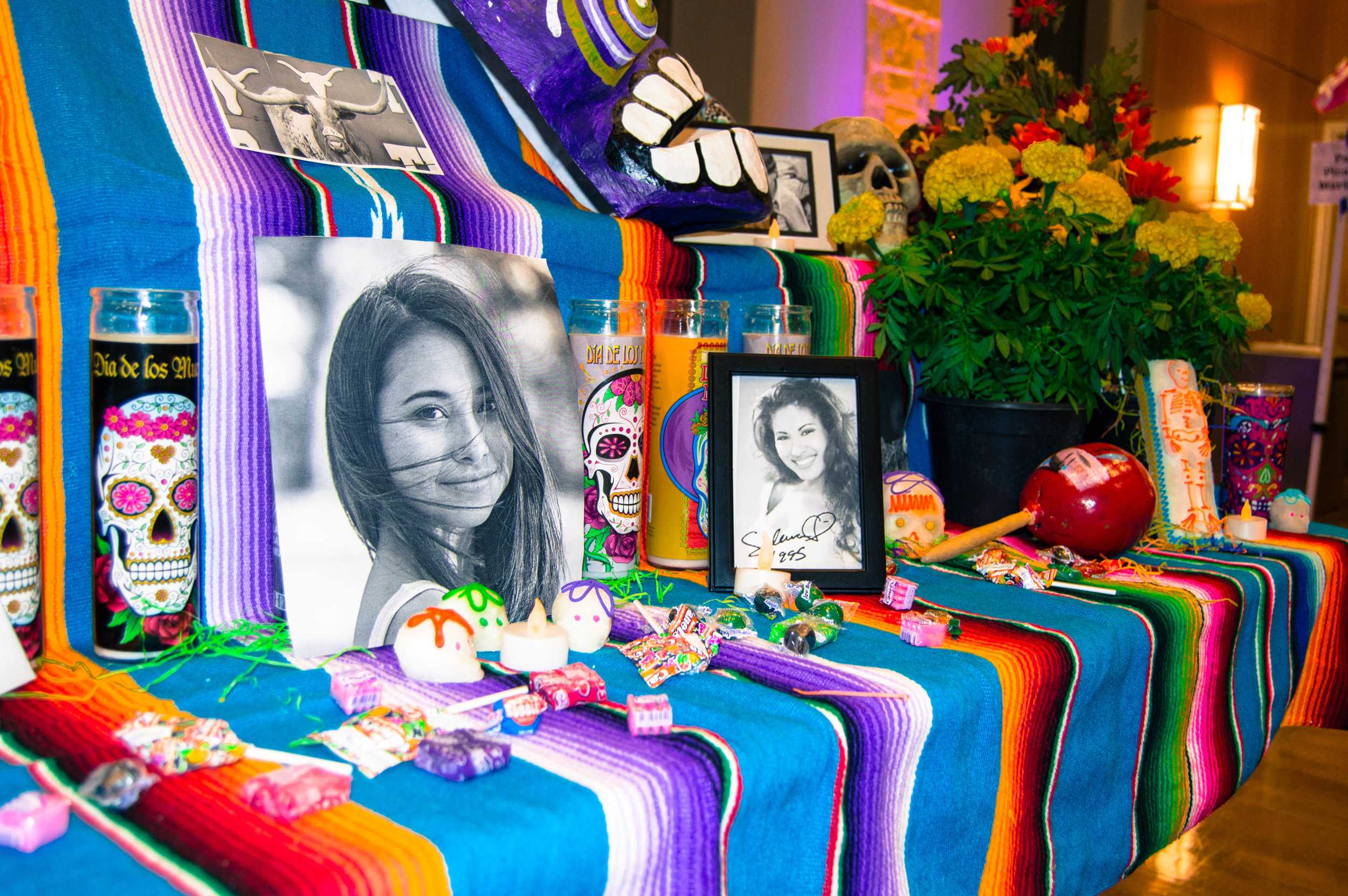   A photo of Haruka Weiser was surrounded by candles, Mexican candy and marigolds at MACC’s community altar.   