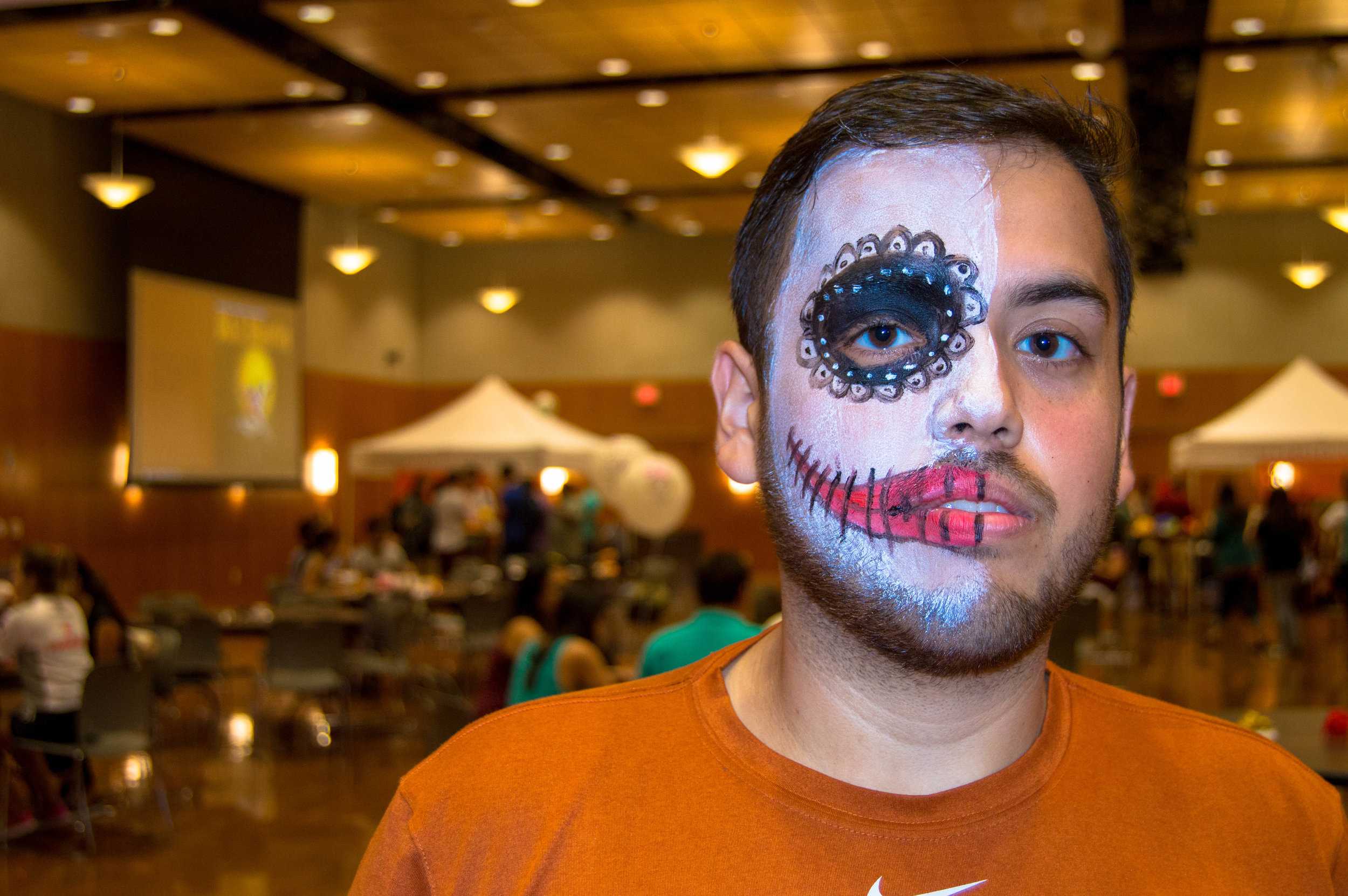   Attendee Toby embraces the half-painted face which stands for the quick transition between life and death.   