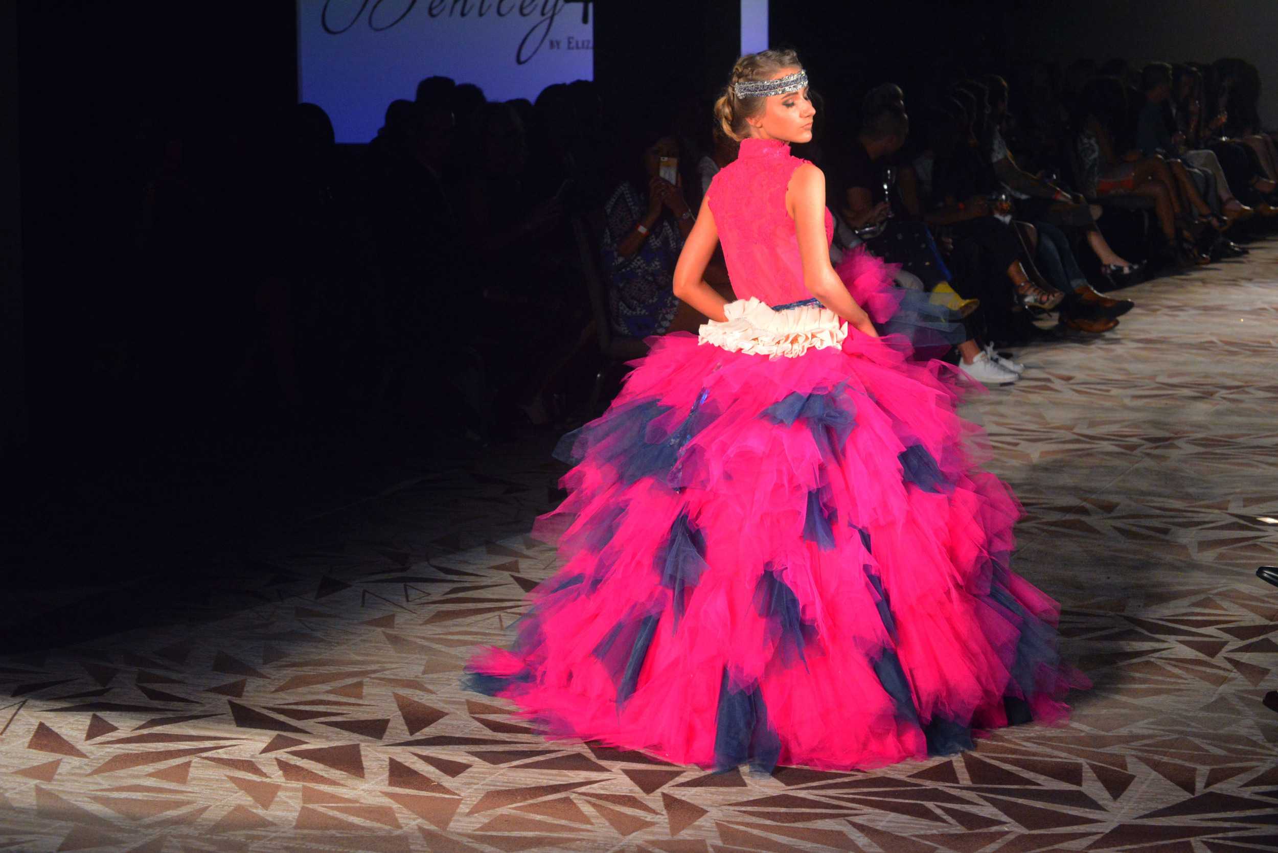   A hot pink and navy tulle ball gown opens Bentley + Lane’s show on Saturday, April 23. Photo by Dahlia Dandashi.  