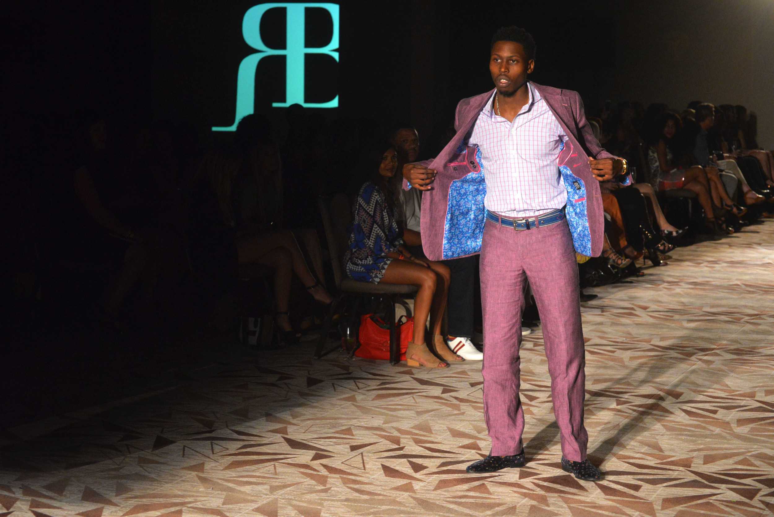   A model shows off the interior lining of his Ross Bennett suit jacket. Photo by Dahlia Dandashi.     