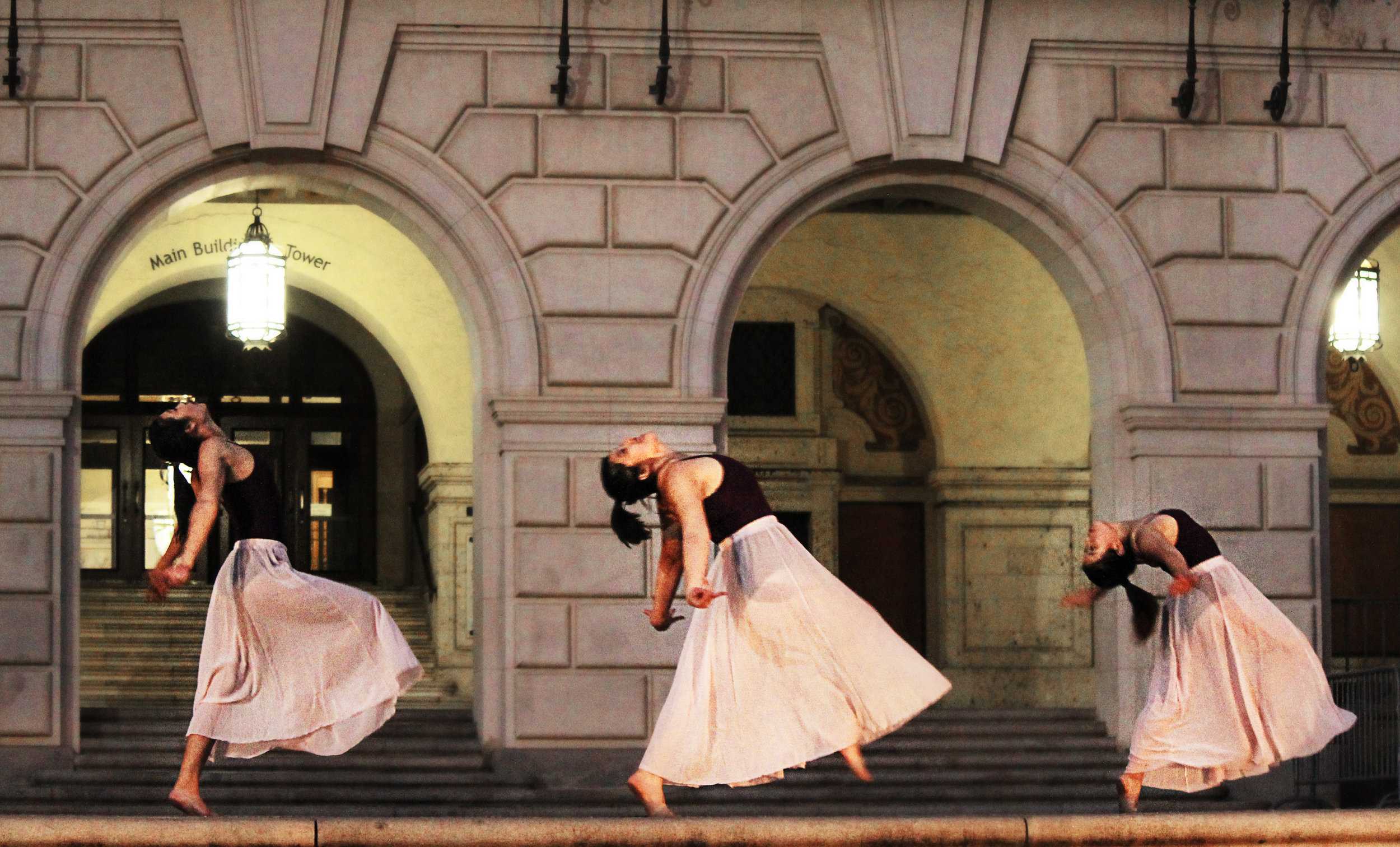   Dancers synchronize a fall.  