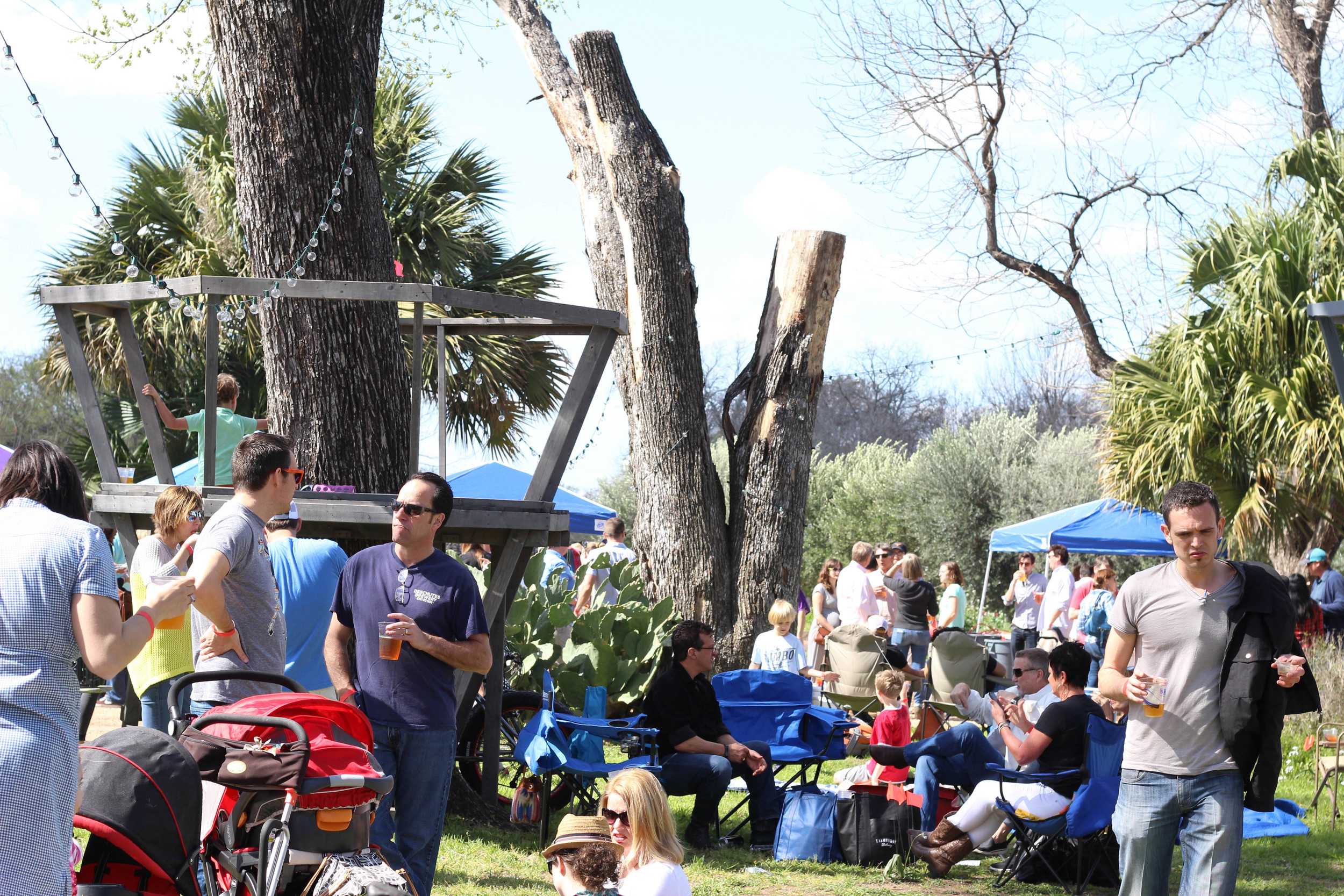   People set up chairs and blankets as they relax and hangout with other spectators.  