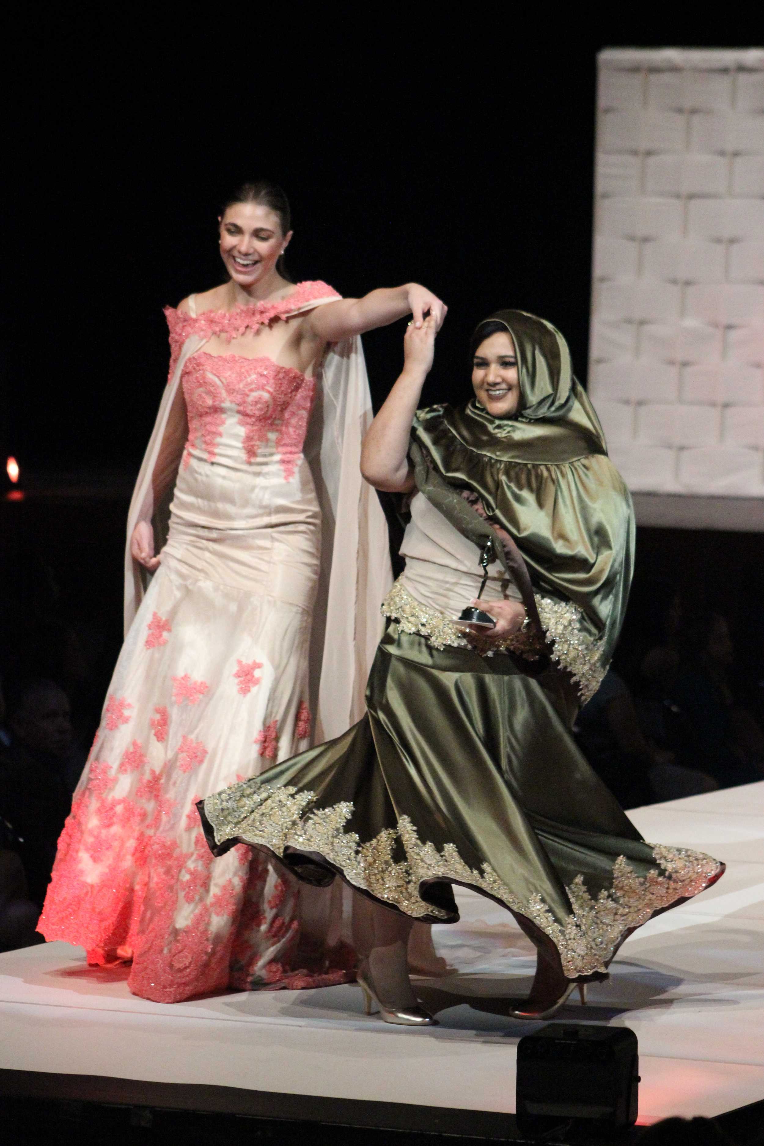   Designers walk down the runway at the end of the fashion show with their models. Pictured here is designer, Tasneem Saifee.     