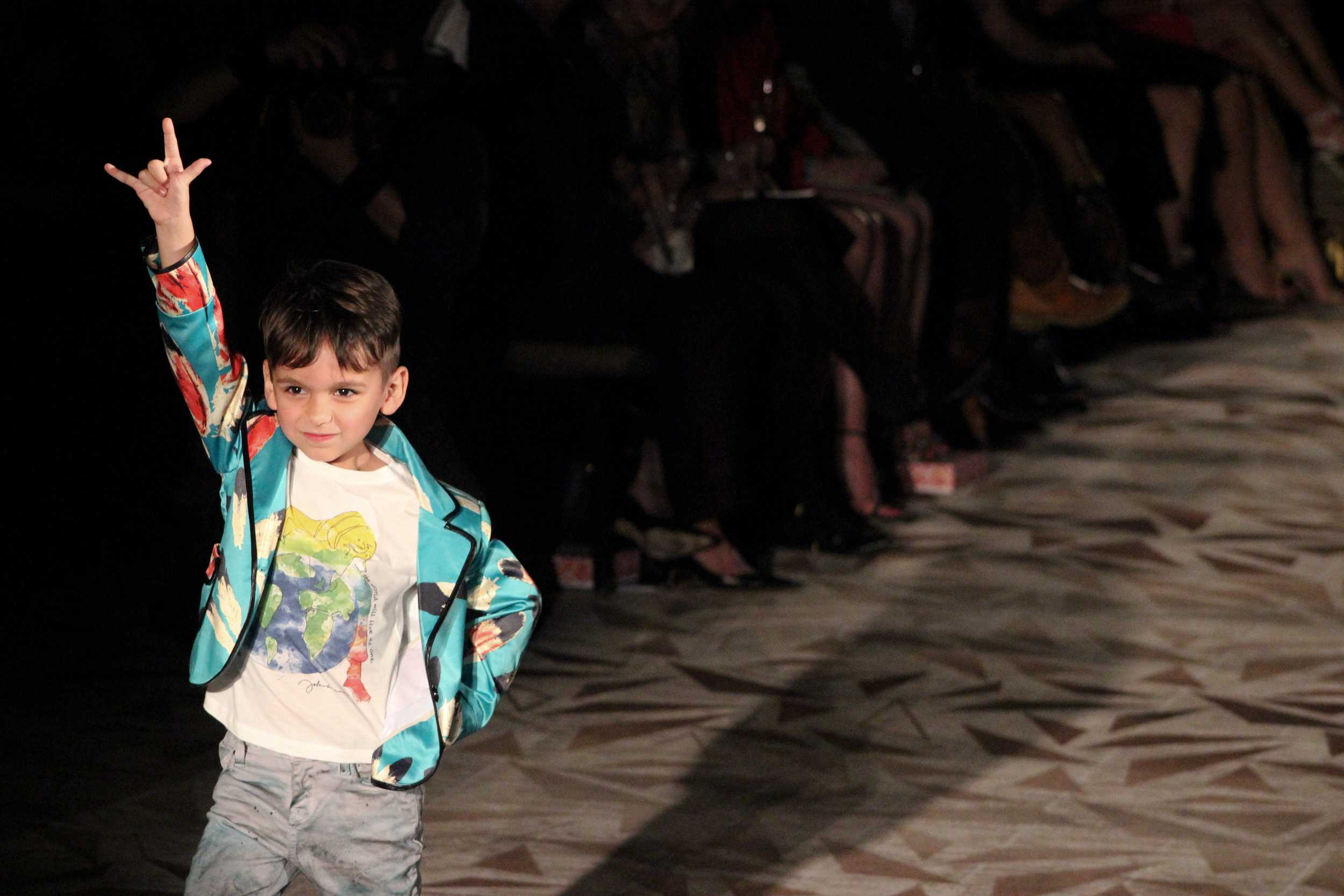   A young model kicks rocks the runway with this Jeffrey Sebelia look. Photo by Miranda Chiechi.  