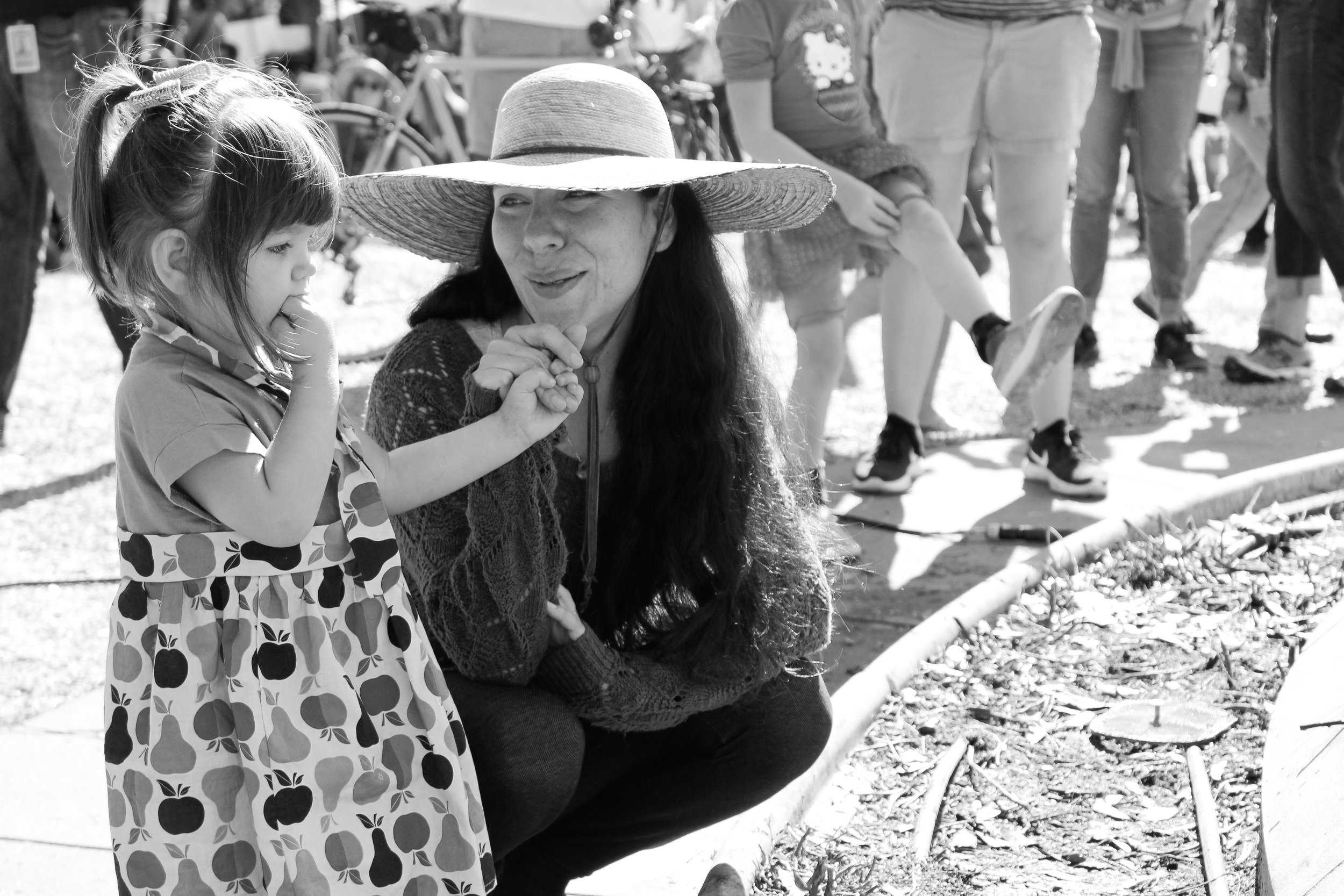   Mother and daughter share a sweet moment by the Capitol pond.     