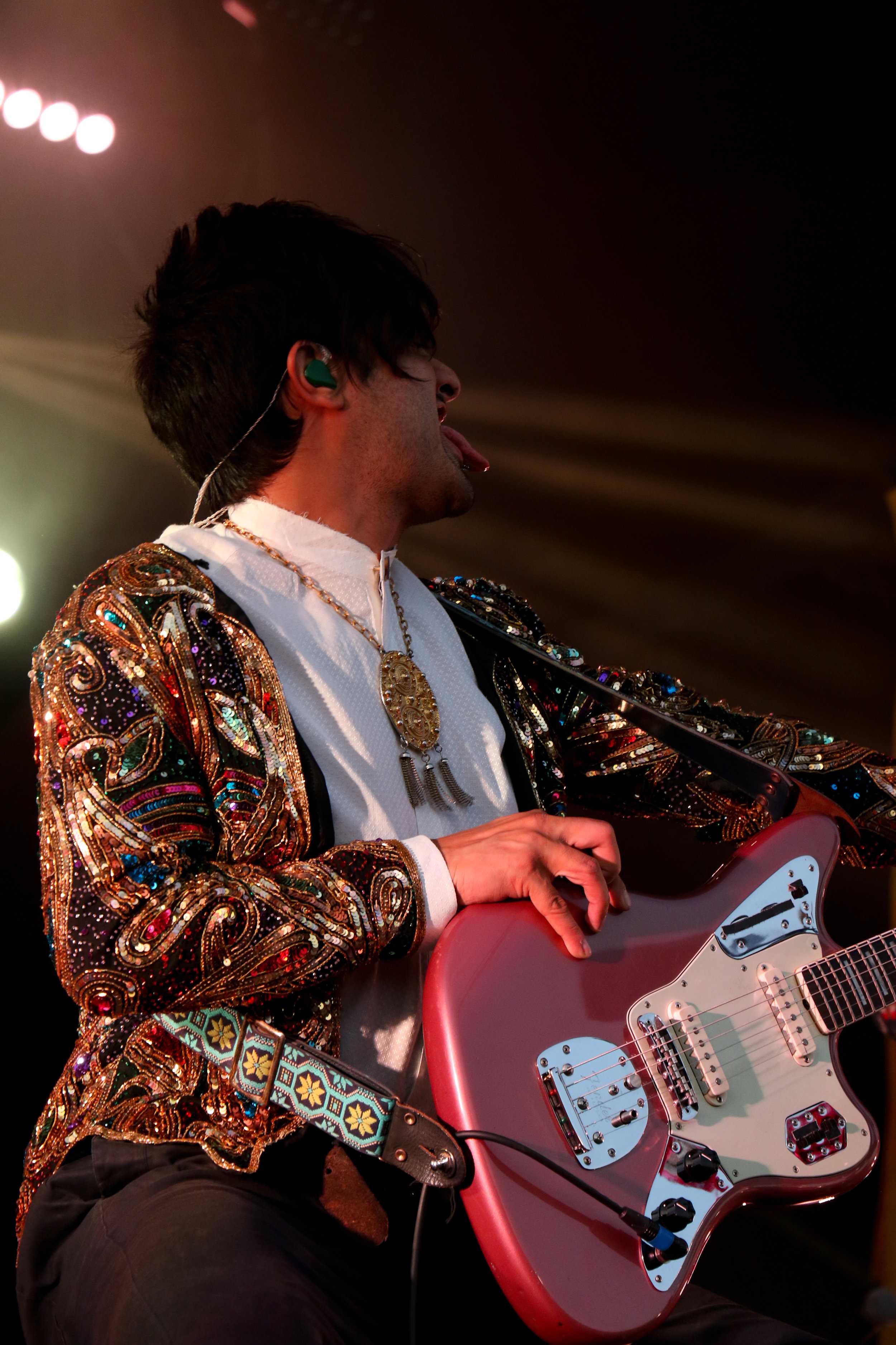   Sameer Gadhia, frontman of Young The Giant, gets down during one of the songs.  