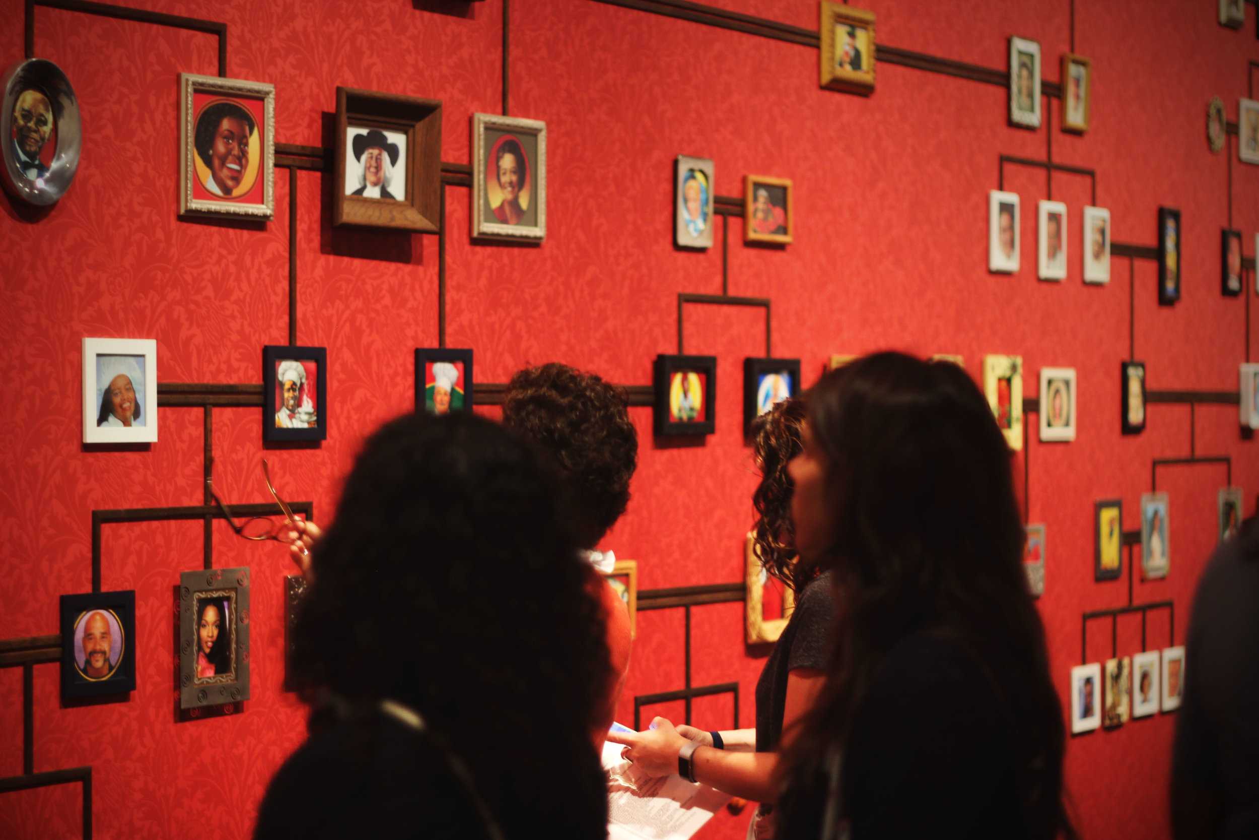   Walking through the newly installed “Curiouser” exhibit people explore her series “The Genealogy of the Supermarket,”&nbsp;a piece organizing popular images of products and people into a family tree.  