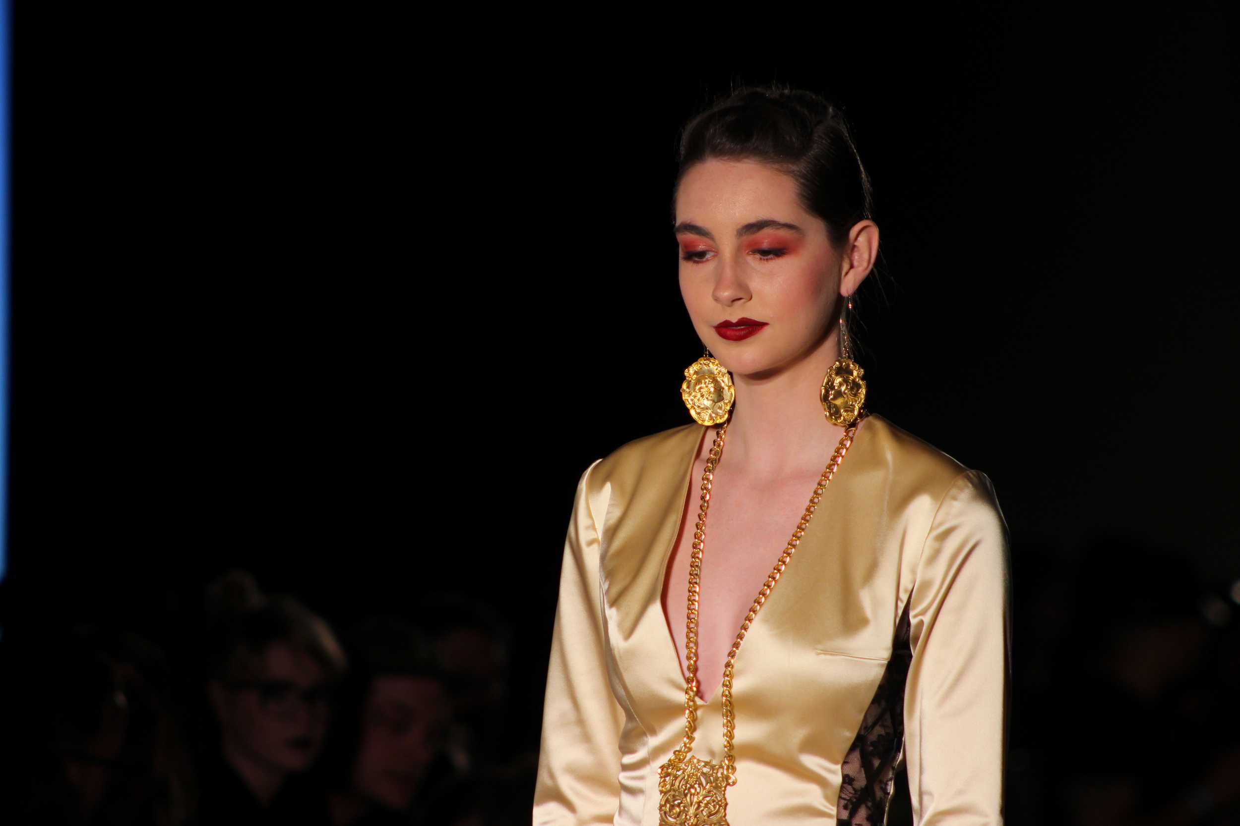   Bright pink eyeshadow on a model compliments Sally Daneshjou’s elegant satin and lace gown. Photo by Miranda Chiechi.  