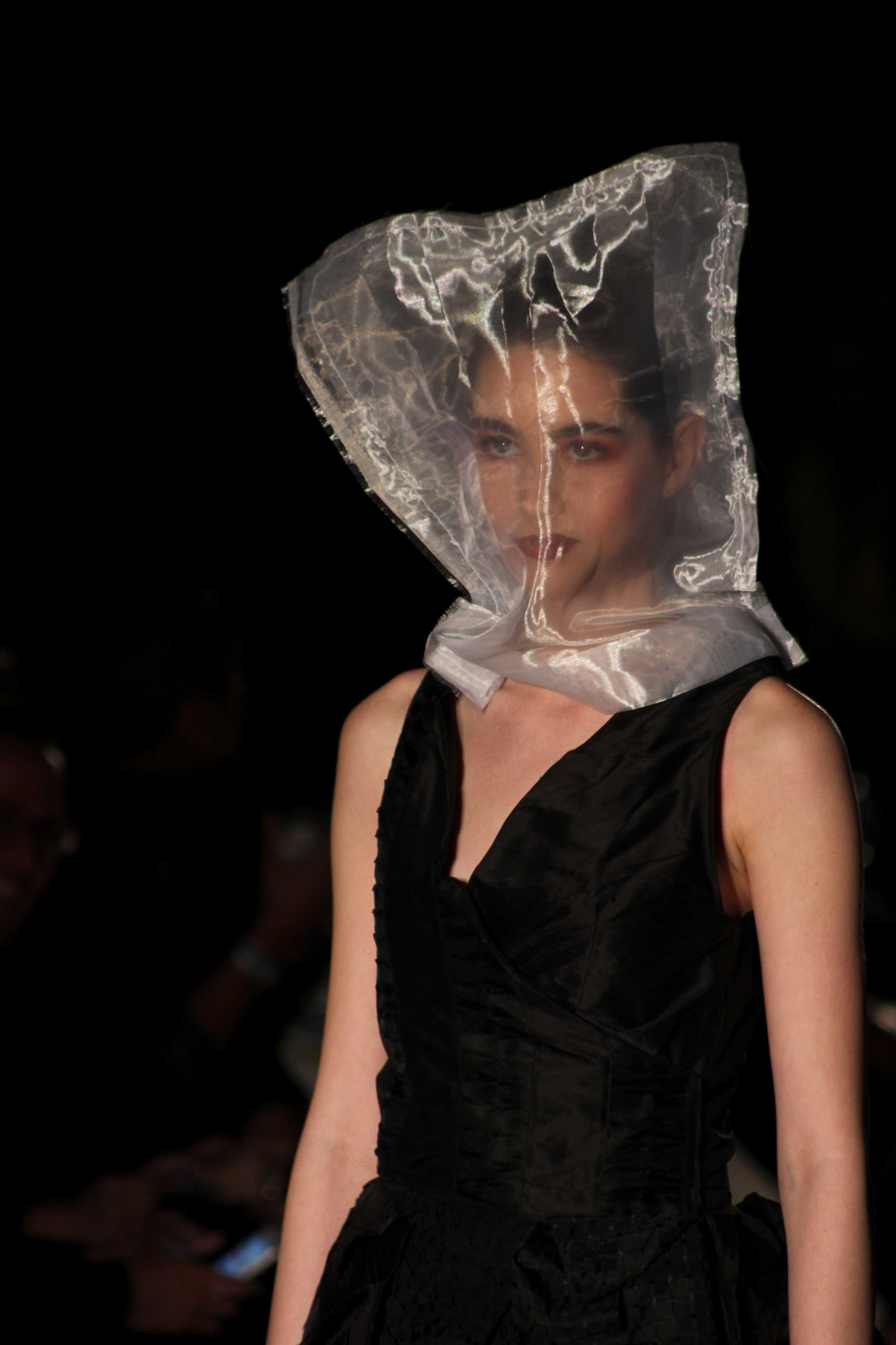   All focus is on Gail Chovan’s dress as the model’s face is obscured by a transparent bag. Photo by Miranda Chiechi.  