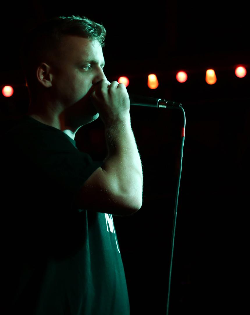  Open Mic Exchange coordinator Adam Protextor, known as “P-Tek,” introduces performers to the Spider House stage. 