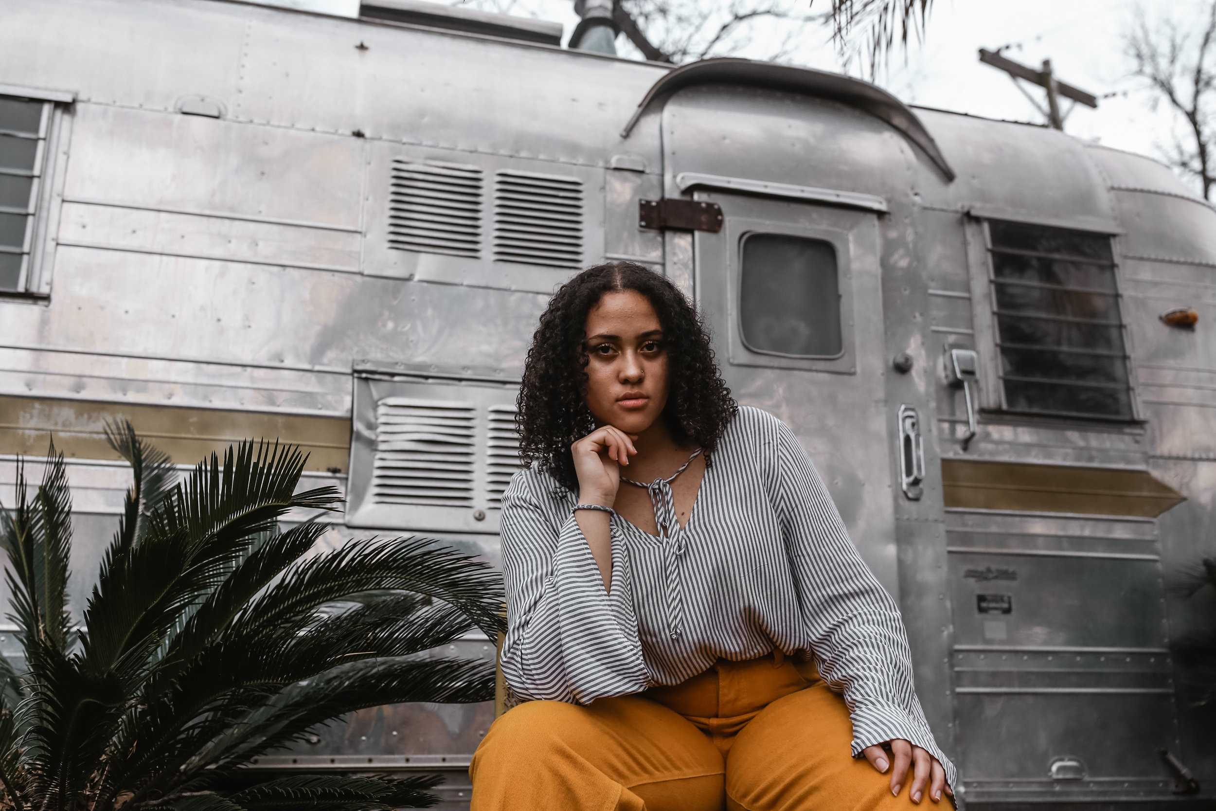   Jacqueline Briddell wears a pair of mustard yellow pants at Tillery Street Plant Company.  